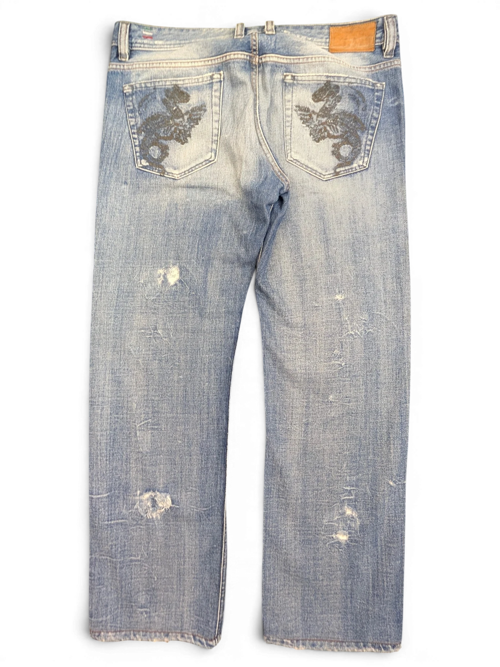 JAKE & IPI light wash denim jeans with distressed details and embroidered dragon design on back pockets. W36 L34.
