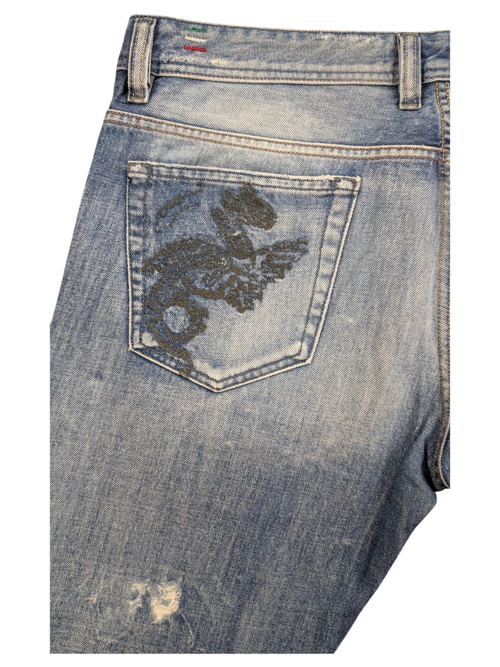 JAKE & IPI light wash denim jeans with embroidered dragon on back pocket and distressed detail.
