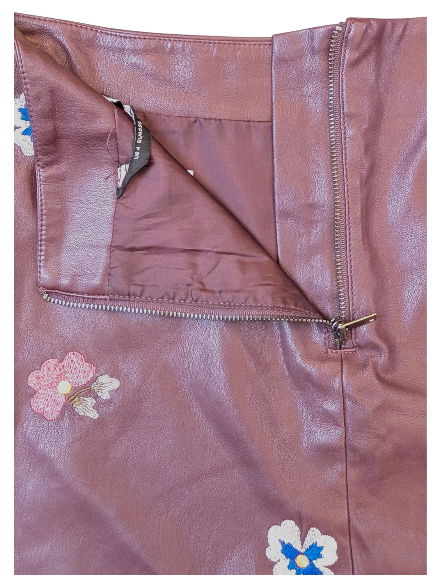 JAKE & IPI burgundy faux leather mini skirt with floral embroidery and side zipper closure.