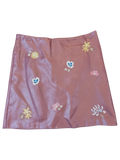 JAKE & IPI mauve faux leather mini skirt featuring delicate multi-colored floral embroidery throughout.