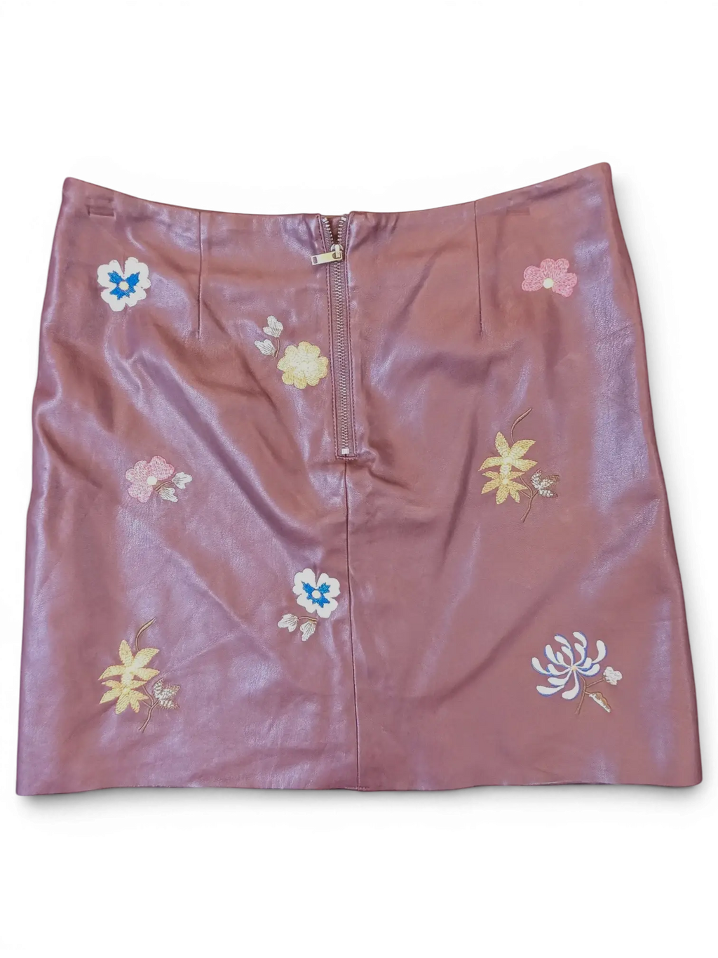 JAKE & IPI mauve faux leather mini skirt with colorful floral embroidery and a front zipper closure.
