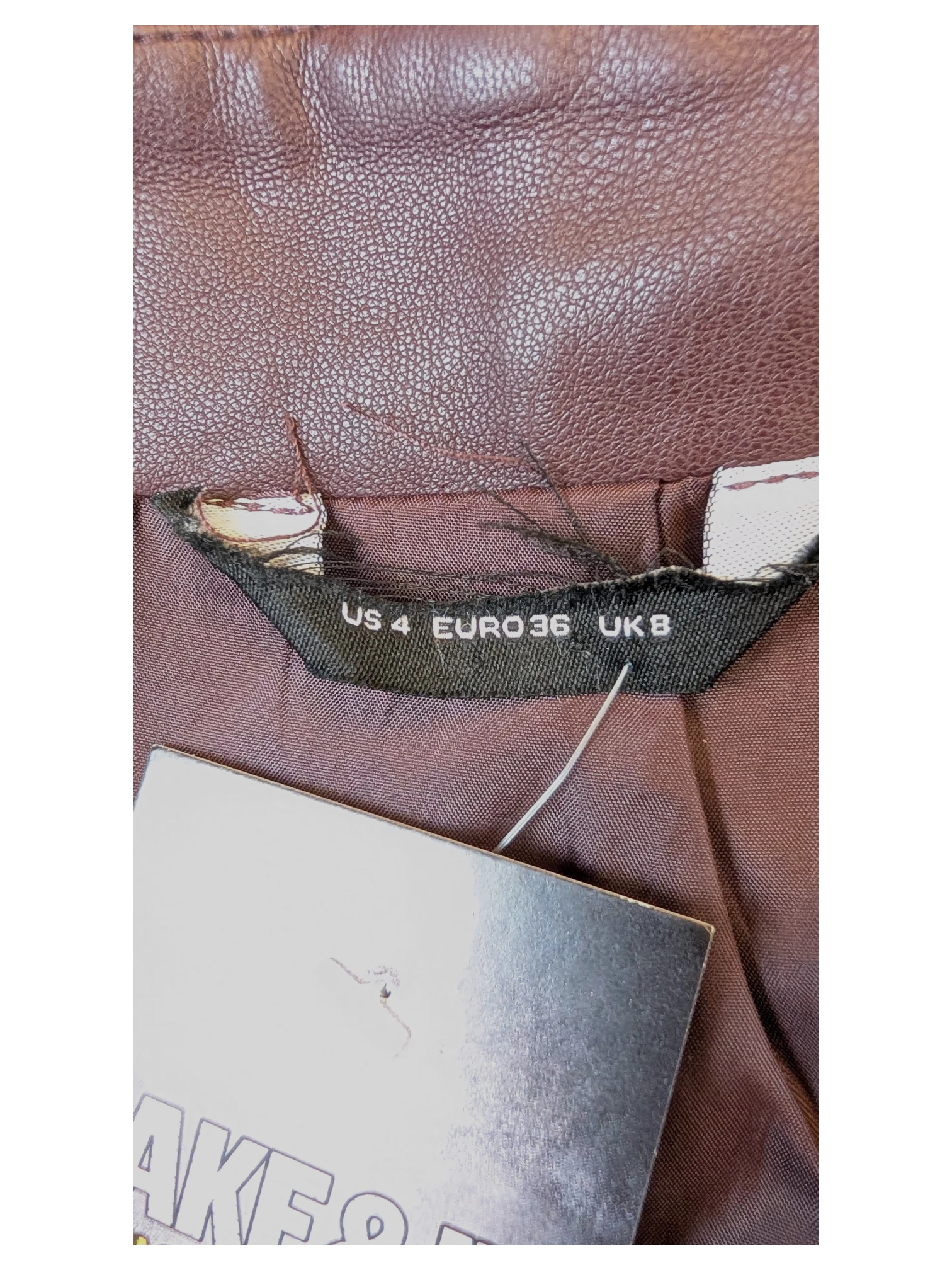 JAKE & IPI brown faux leather mini skirt with size label showing US 4, Euro 36, and UK 8.