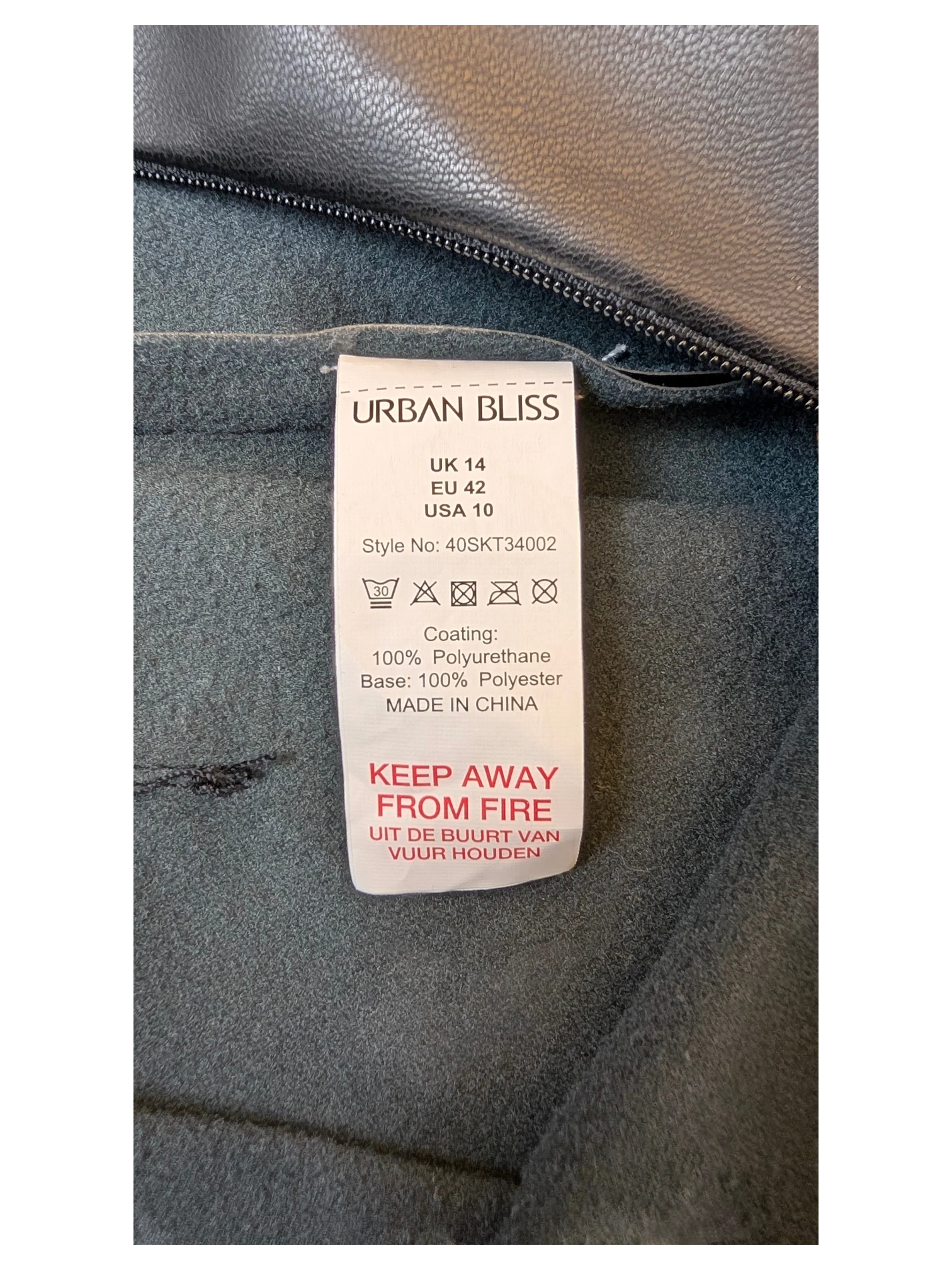 JAKE & IPI Urban Bliss black faux leather pleated mini skirt care label and interior fabric texture