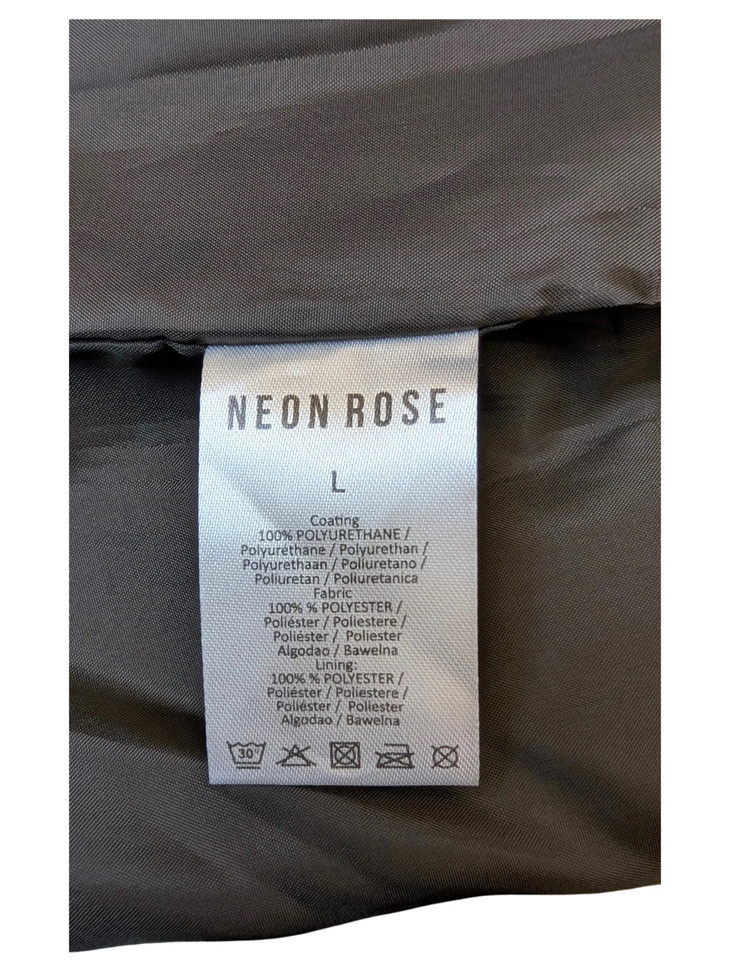 JAKE & IPI Neon Rose faux leather mini skirt care label showing 100% polyurethane coating and polyester lining