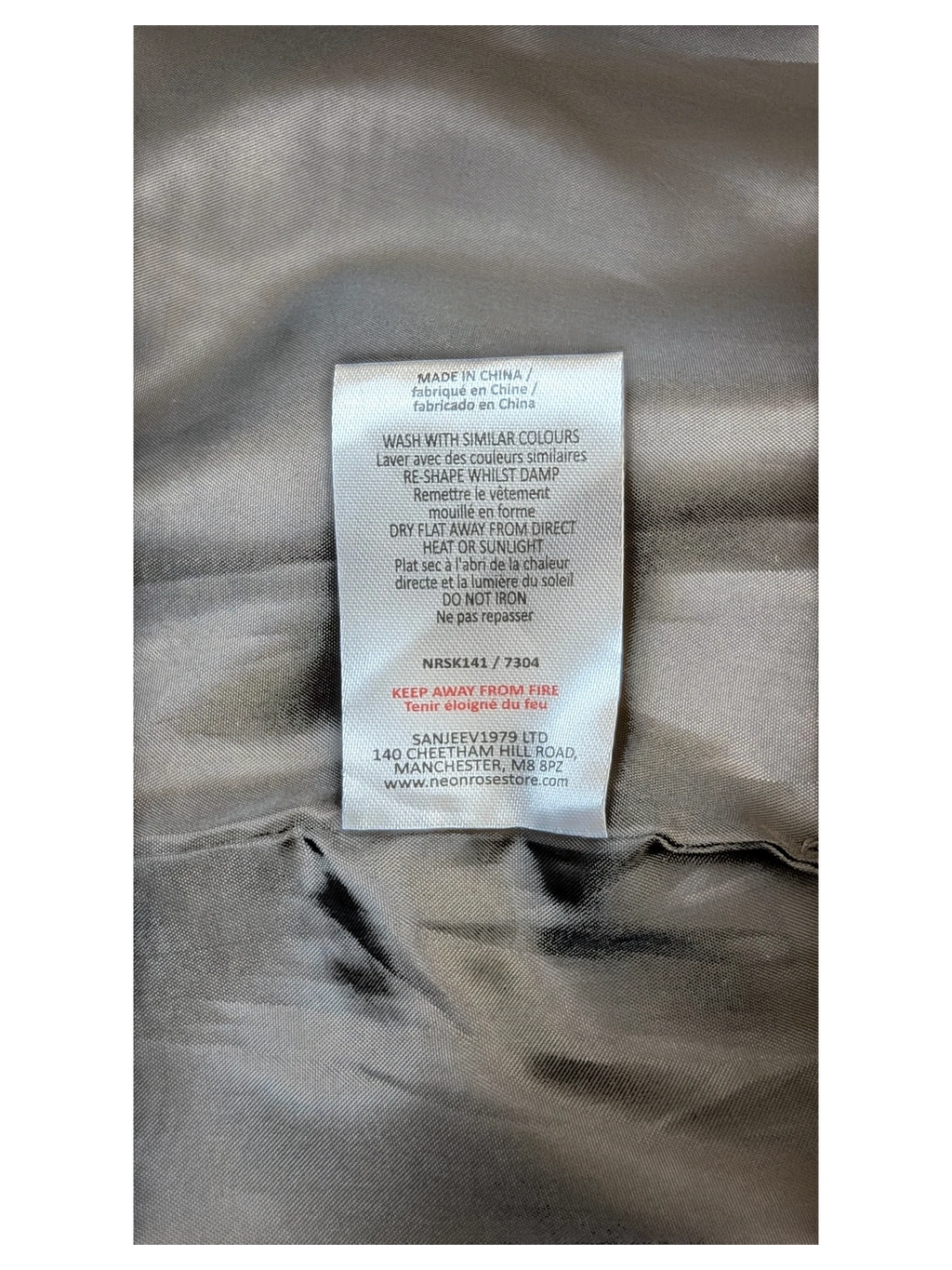 JAKE & IPI care label for Neon Rose paneled faux leather mini skirt with washing instructions and fabric details.