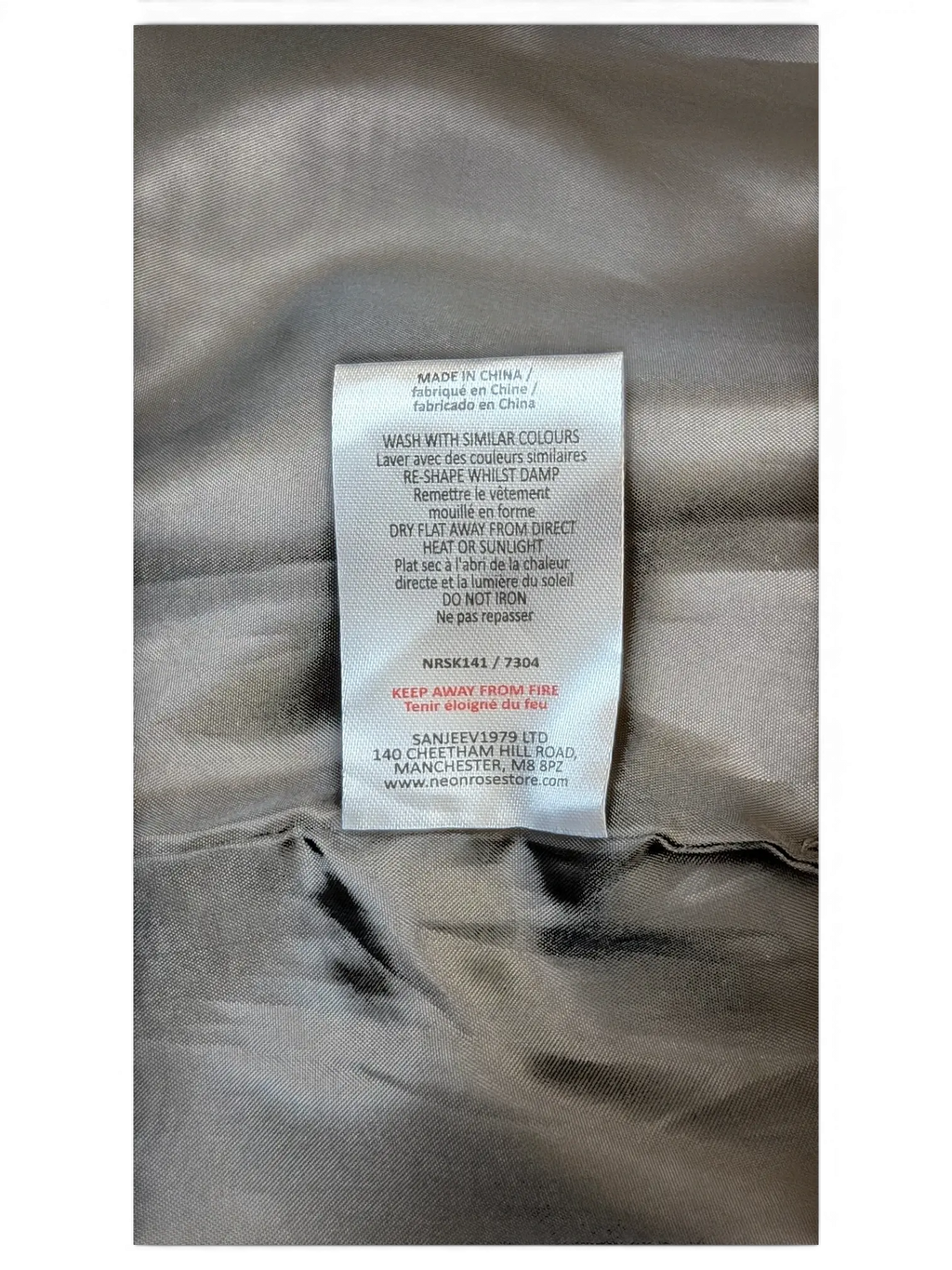 JAKE & IPI care label for Neon Rose paneled faux leather mini skirt with washing instructions and fabric details.