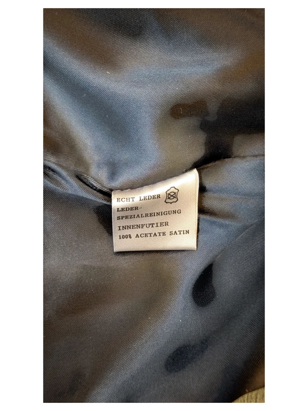 JAKE & IPI Giorgio Mobiani leather skirt care label showing 100% acetate satin lining and genuine leather material