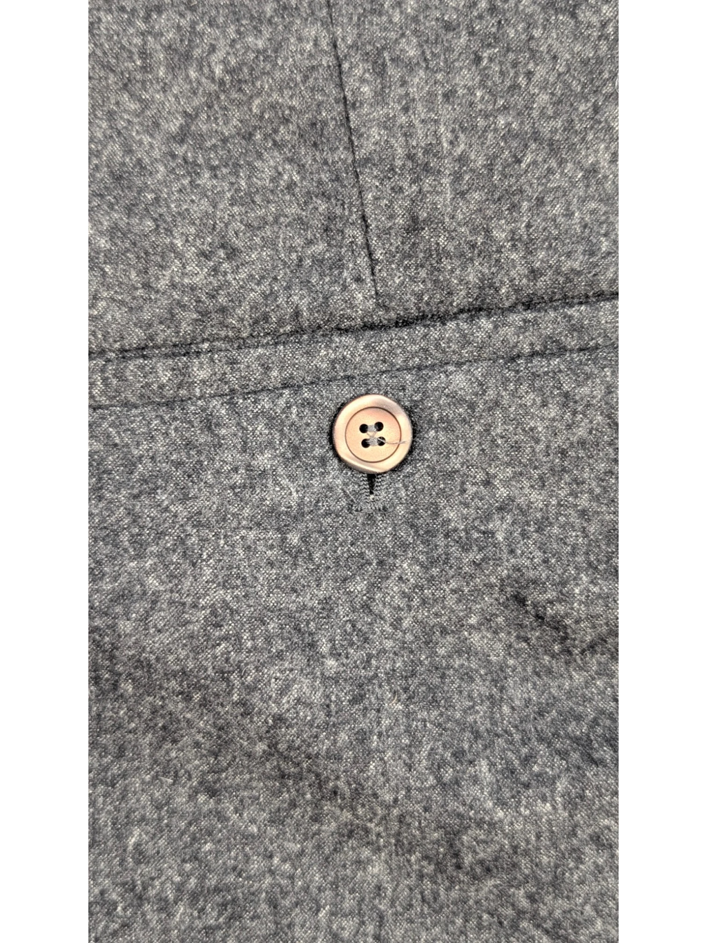 JAKE & IPI grey mélange wool blend flannel tailored trousers with horn-style button detail.