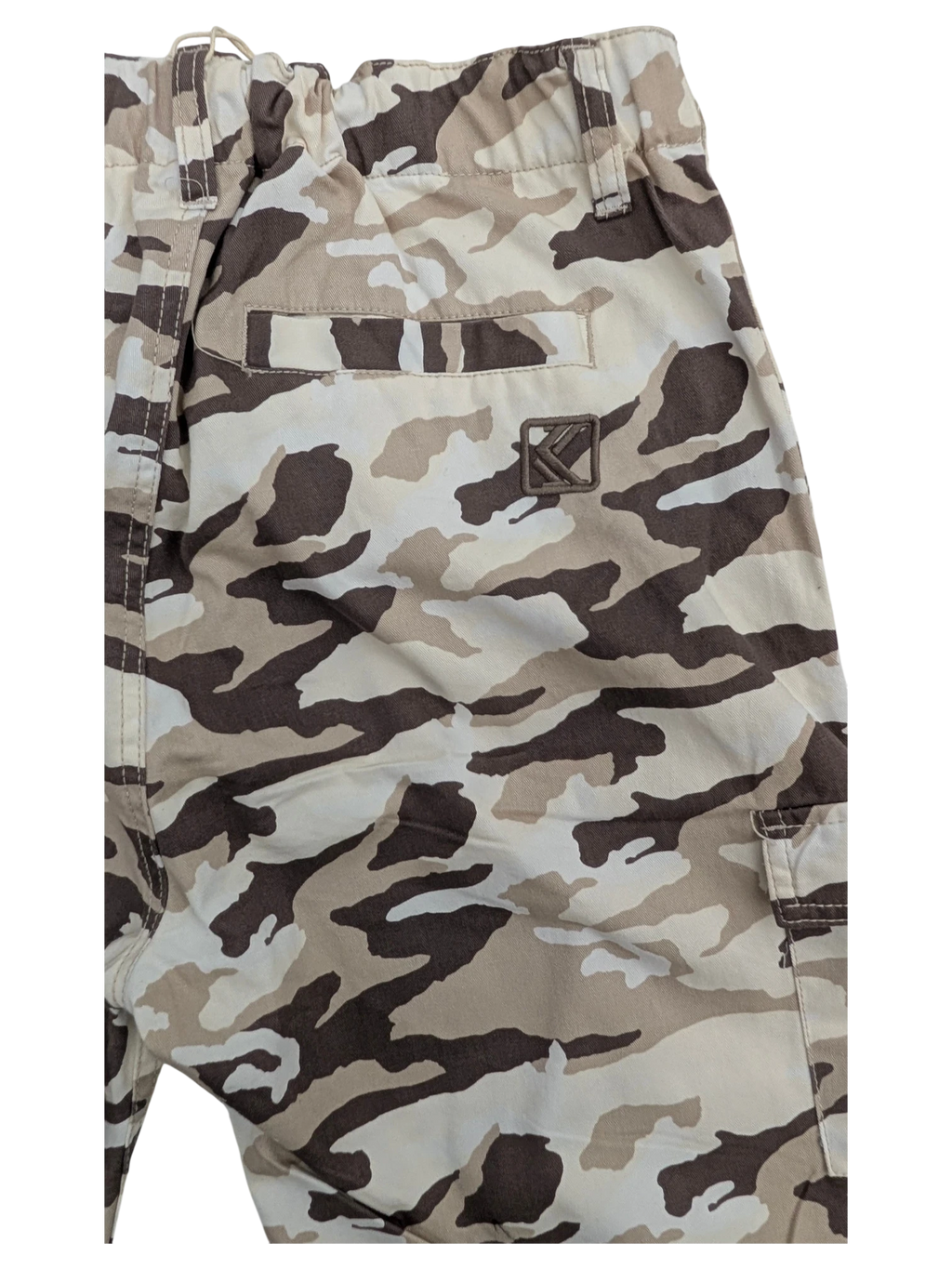 JAKE & IPI Karl Kani camouflage cargo pants in tan, brown, and cream cotton. Features a back pocket with embroidered logo.