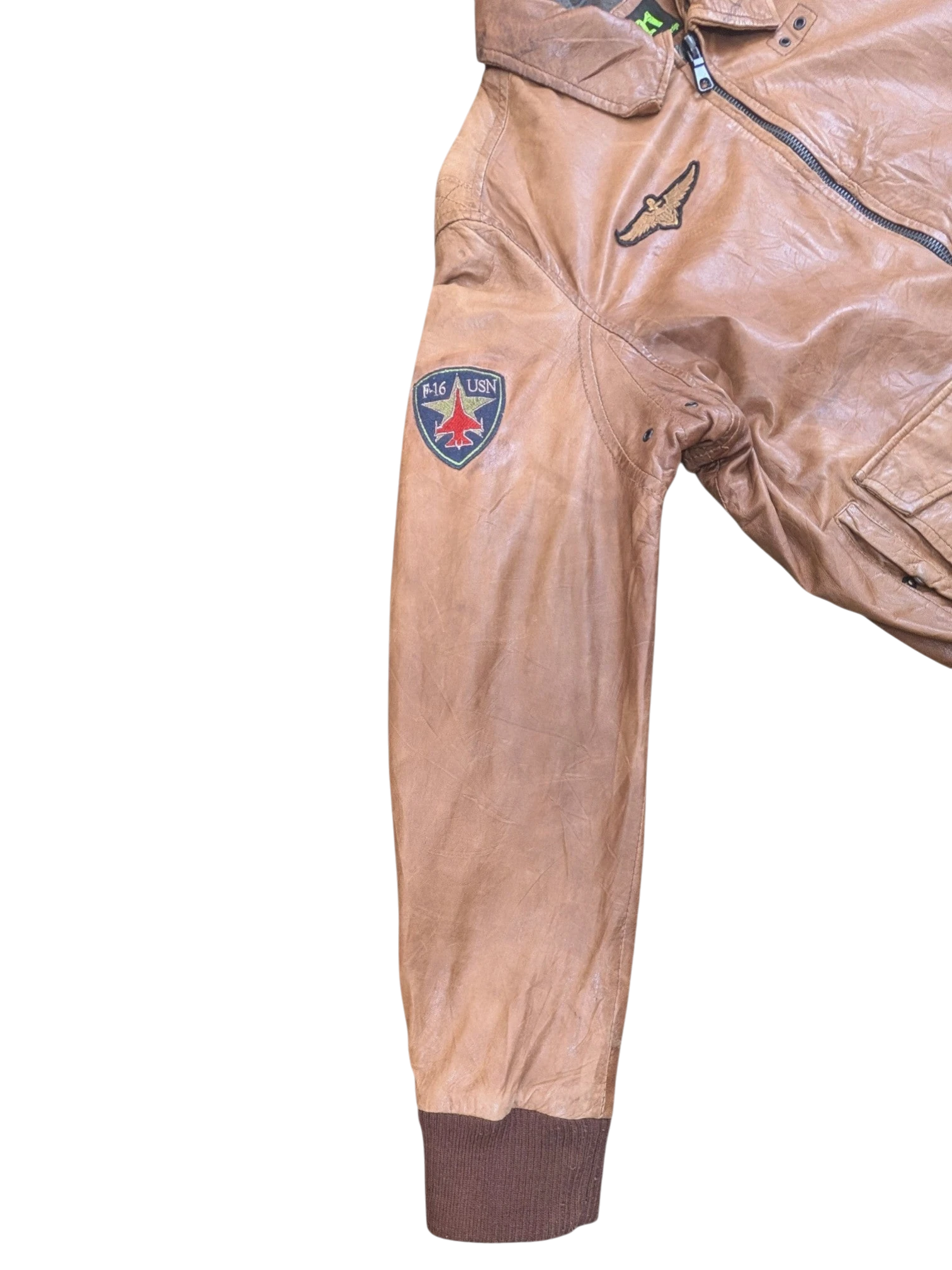 JAKE & IPI tan leather bomber jacket with F-16 USN patch and eagle patch. Ribbed cuffs.