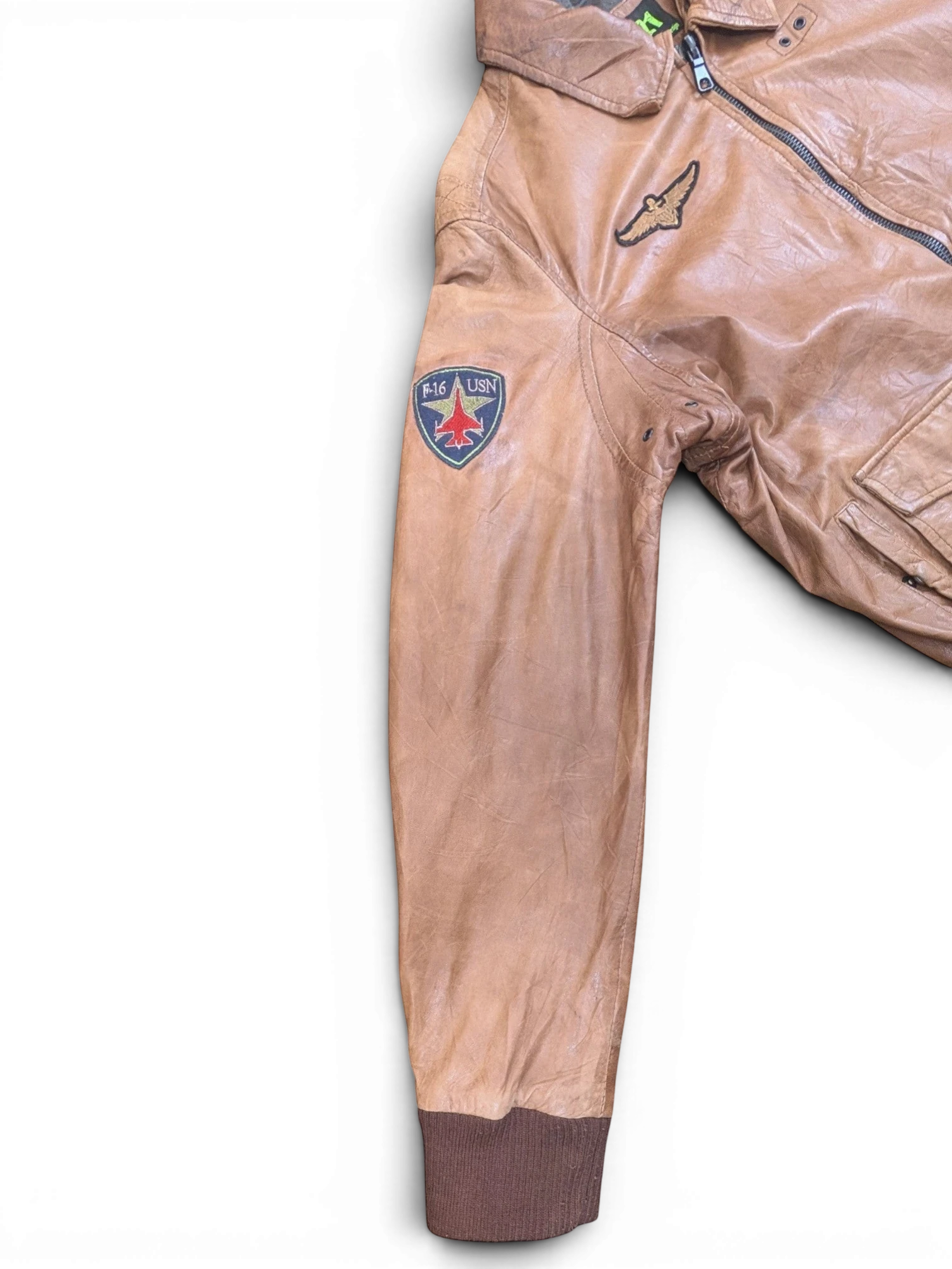 JAKE & IPI tan leather bomber jacket with F-16 USN patch and eagle patch. Ribbed cuffs.