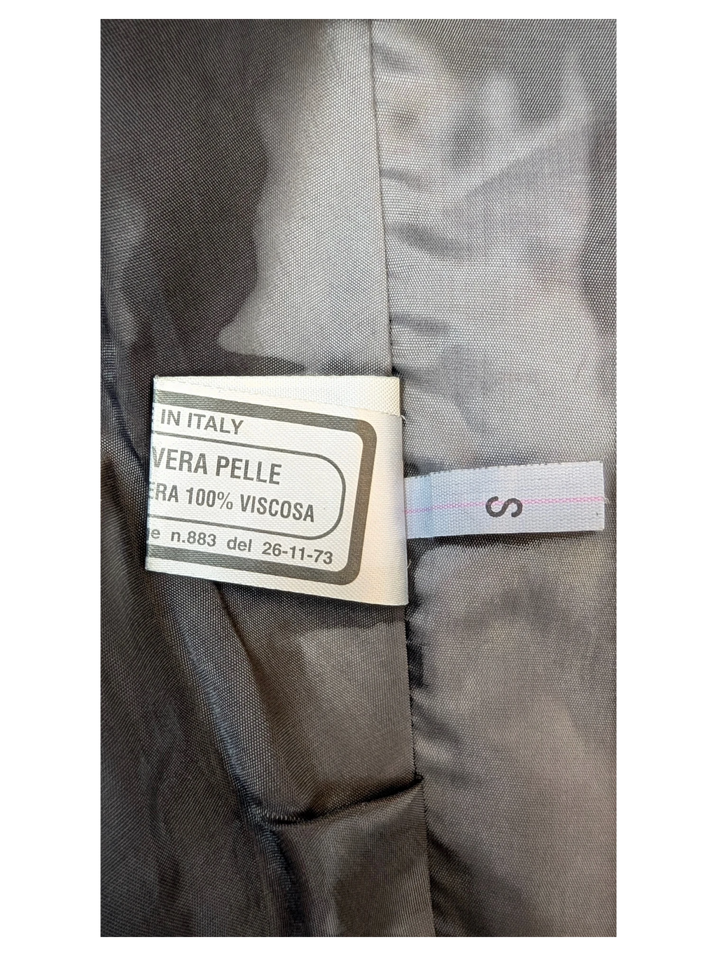 JAKE & IPI classic mini skirt interior label showing genuine leather and viscose lining details.
