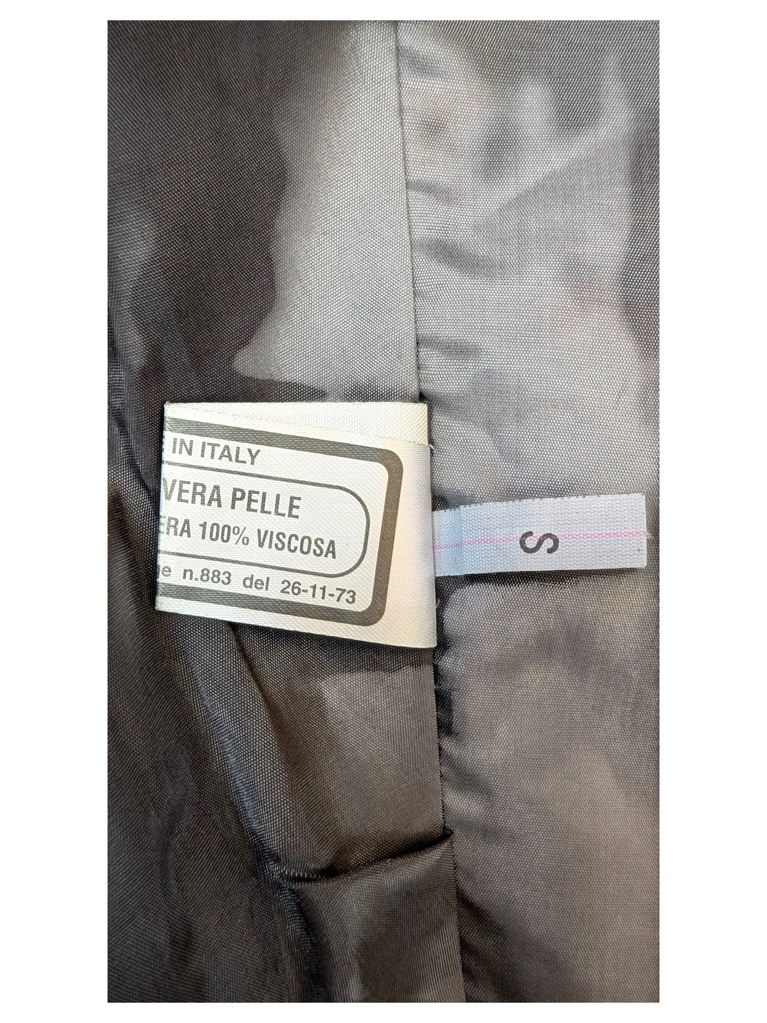 JAKE & IPI classic mini skirt interior label showing genuine leather and viscose lining details.