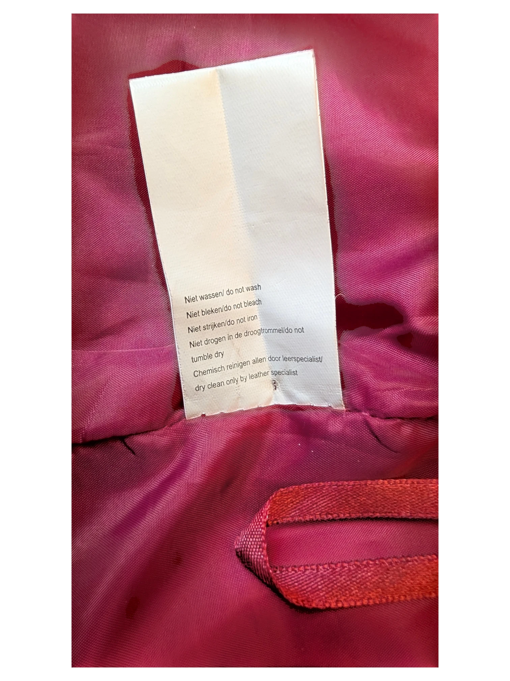 JAKE & IPI Josephine's and Co leather skirt care label with dry clean instructions on a bright pink lining