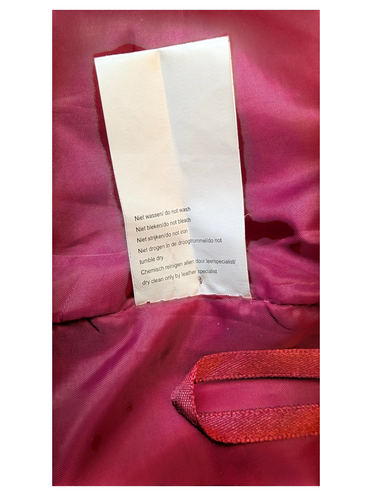 JAKE & IPI Josephine's and Co leather skirt care label with dry clean instructions on a bright pink lining