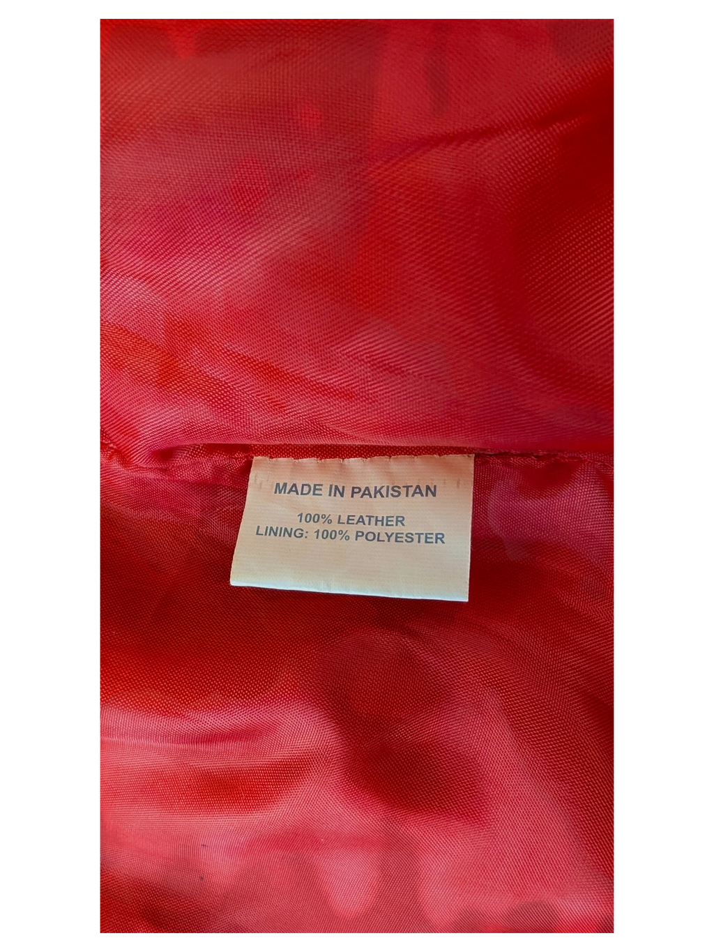 JAKE & IPI leather skirt interior label showing 100% leather construction and red polyester lining.