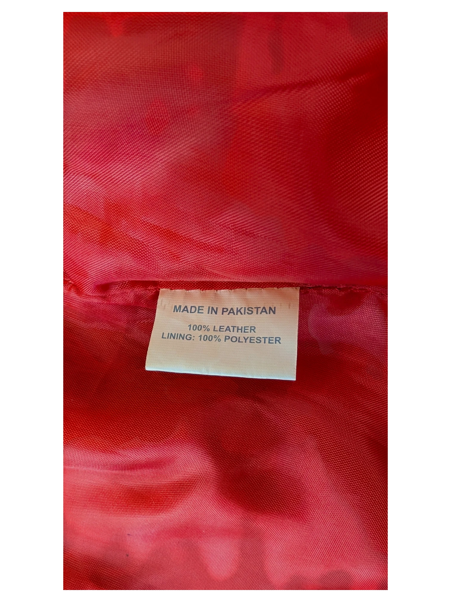 JAKE & IPI leather skirt interior label showing 100% leather construction and red polyester lining.