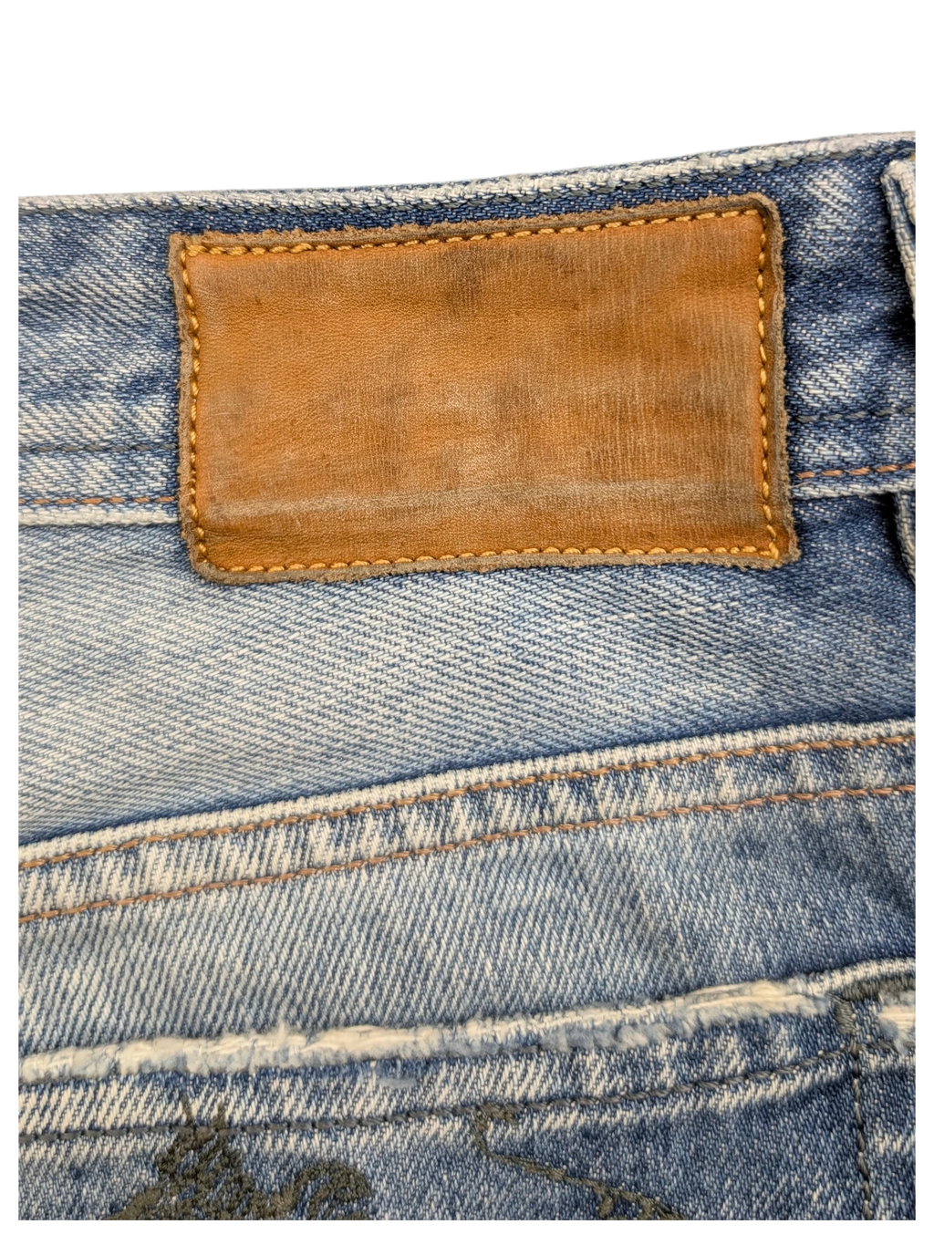 JAKE & IPI light wash denim jeans with brown leather patch and distressed details. W36 L34.