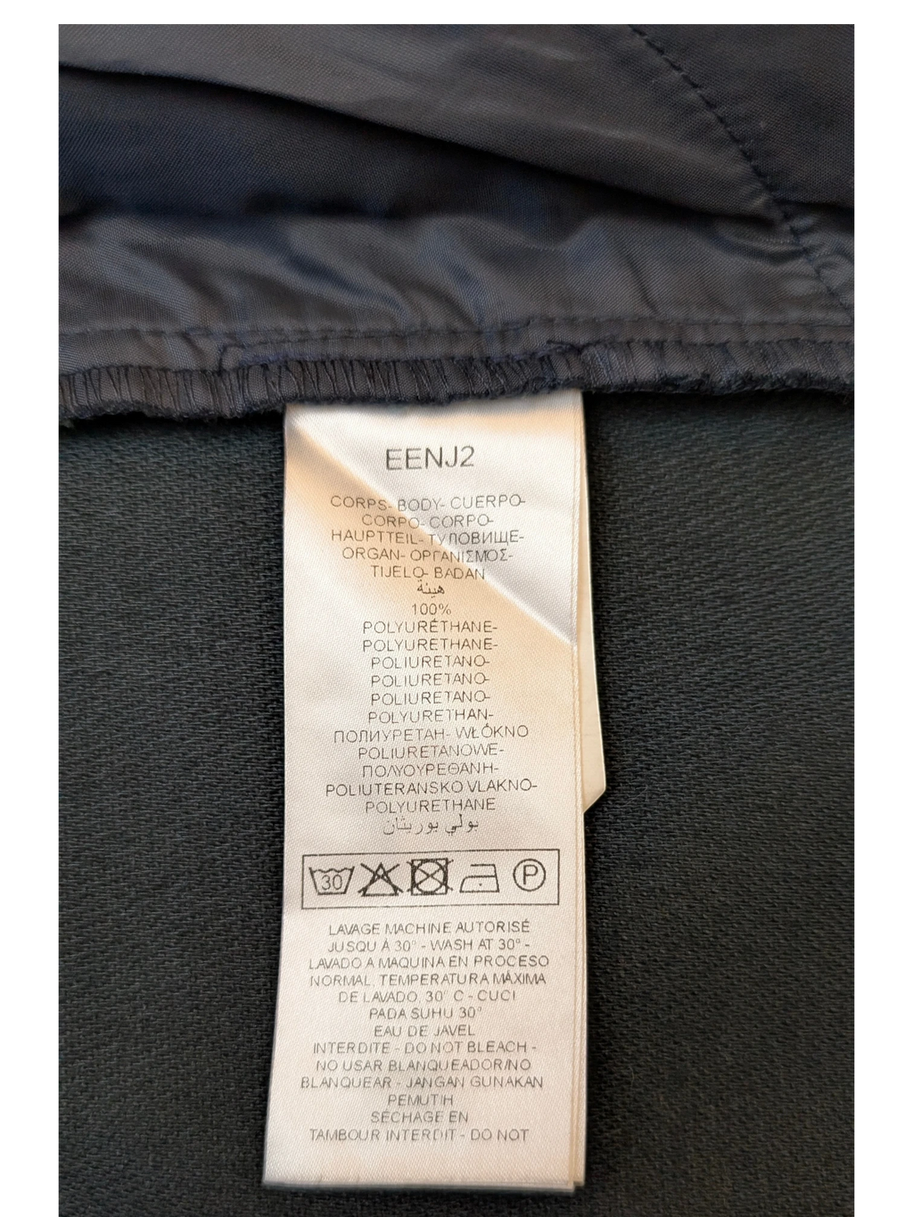 JAKE & IPI NAF NAF black faux leather mini skirt care label showing 100% polyurethane composition