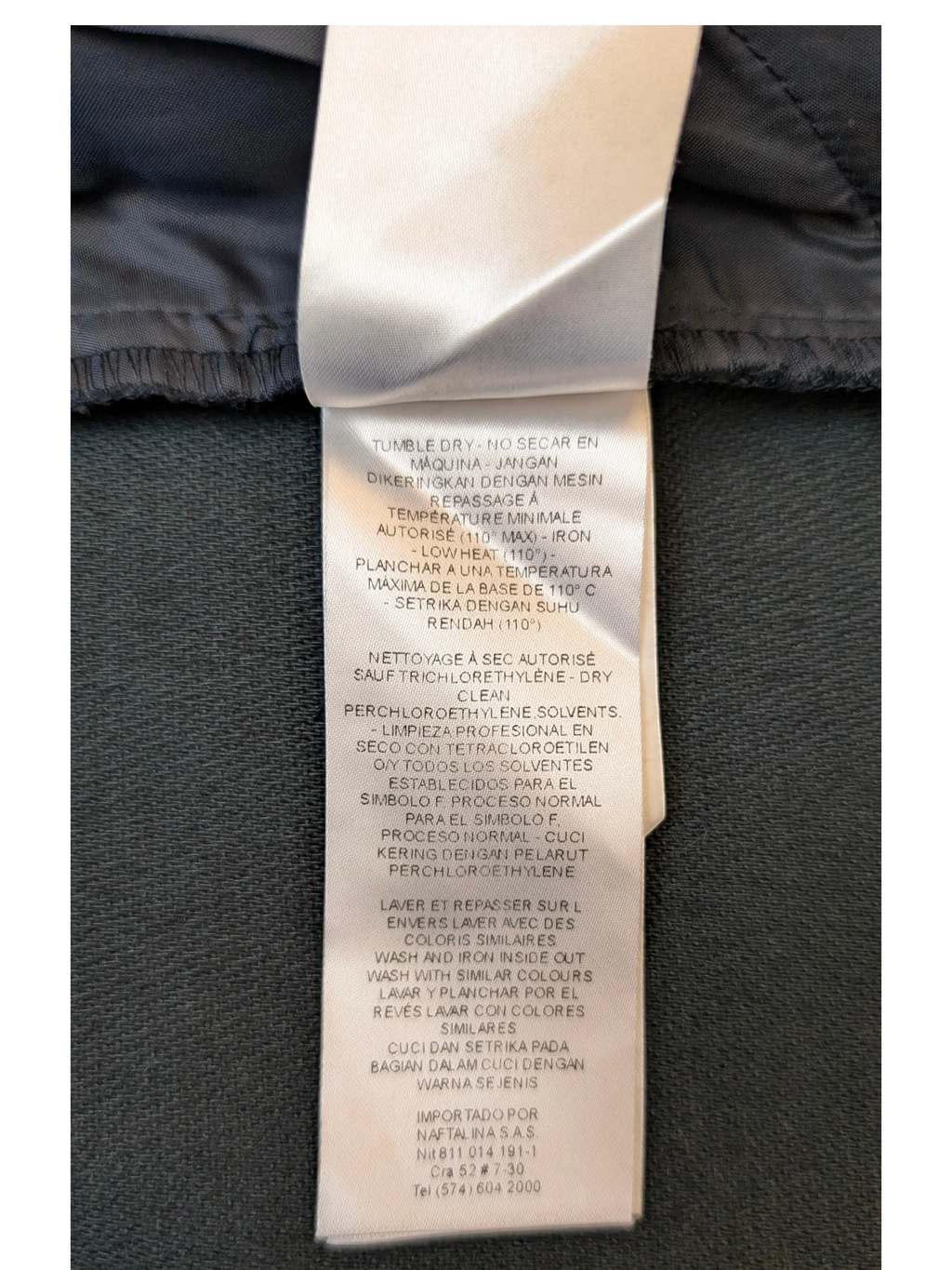 JAKE & IPI NAF NAF faux leather mini skirt care label with washing and ironing instructions in multiple languages.