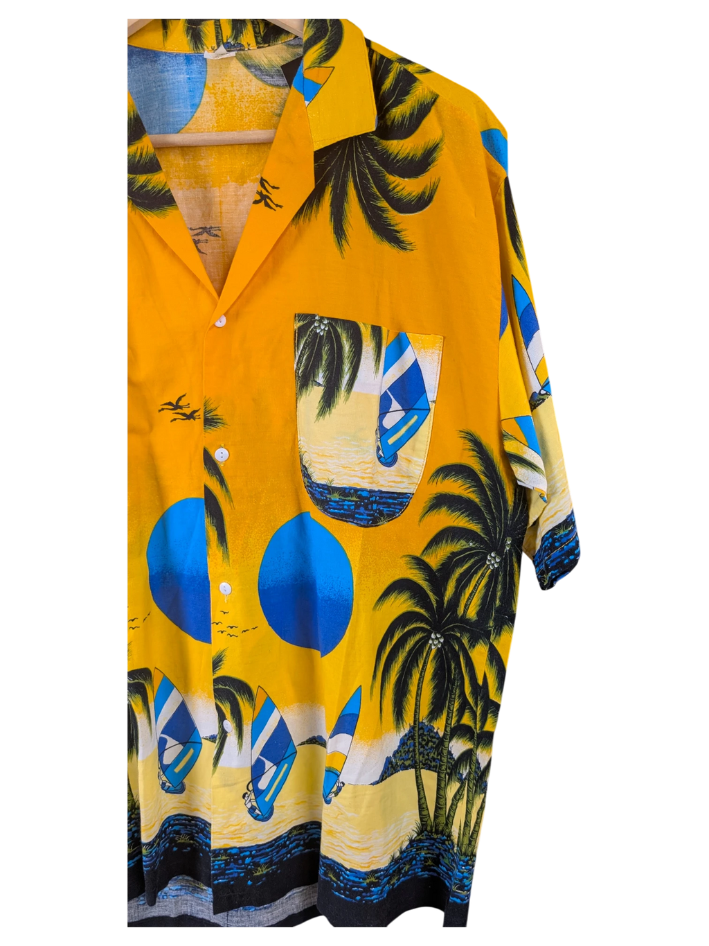 JAKE & IPI orange Hawaiian shirt featuring a tropical beach print with palm trees, sailboats, and blue suns.