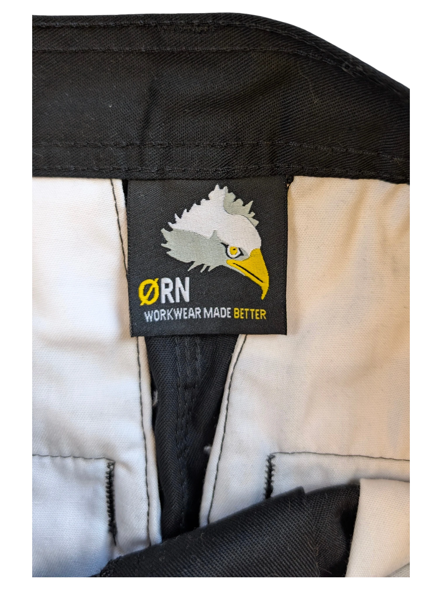 JAKE & IPI black ØRN cargo pants with white interior lining and eagle logo tag.