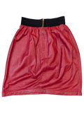 JAKE & IPI red faux leather mini skirt with a black ribbed elastic waistband and front gold zipper detail.