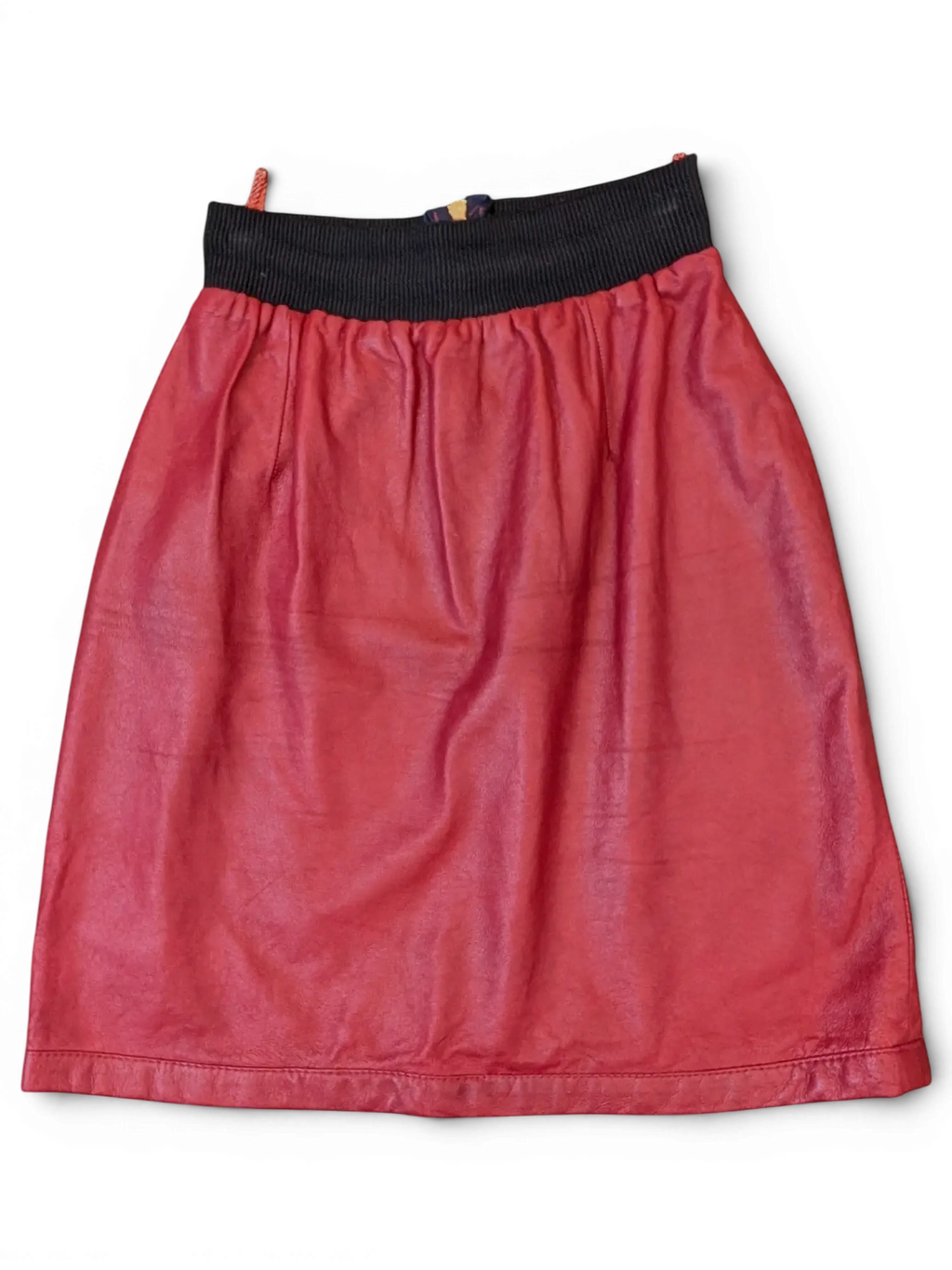 JAKE & IPI red faux leather skirt featuring a comfortable black ribbed elastic waistband and a simple A-line cut.