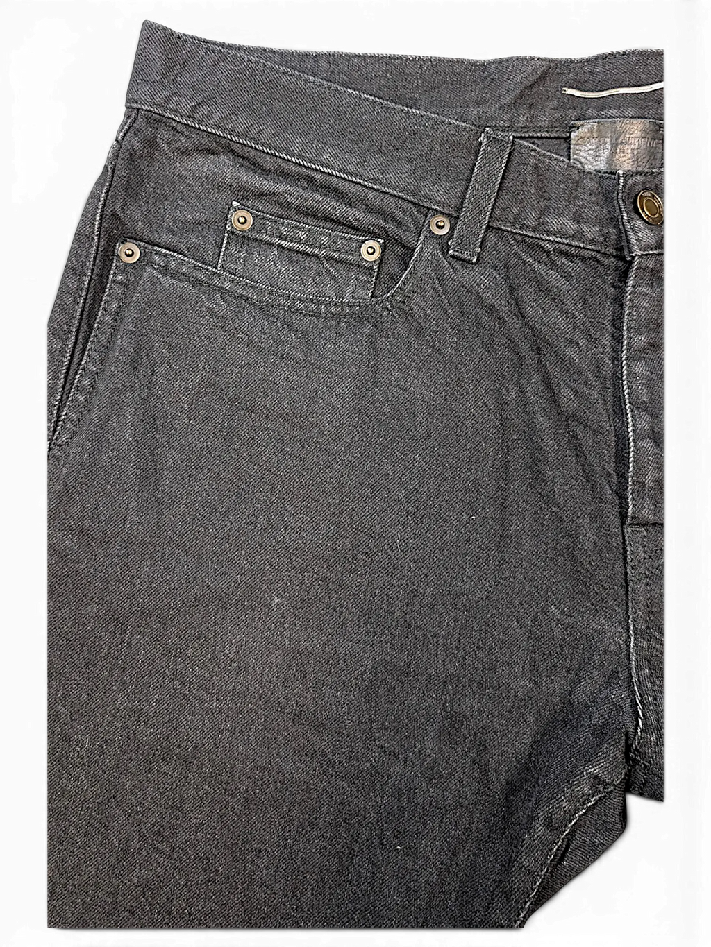JAKE & IPI Saint Laurent black denim jeans featuring a classic five-pocket design with metallic rivets.