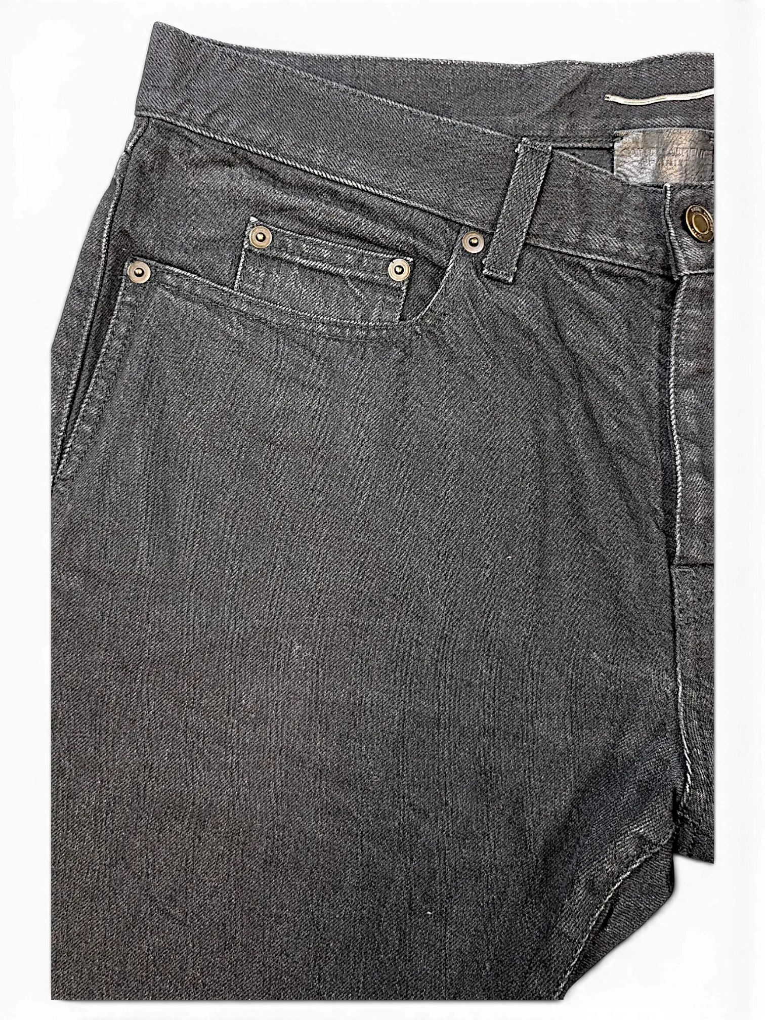 JAKE & IPI Saint Laurent black denim jeans featuring a classic five-pocket design with metallic rivets.
