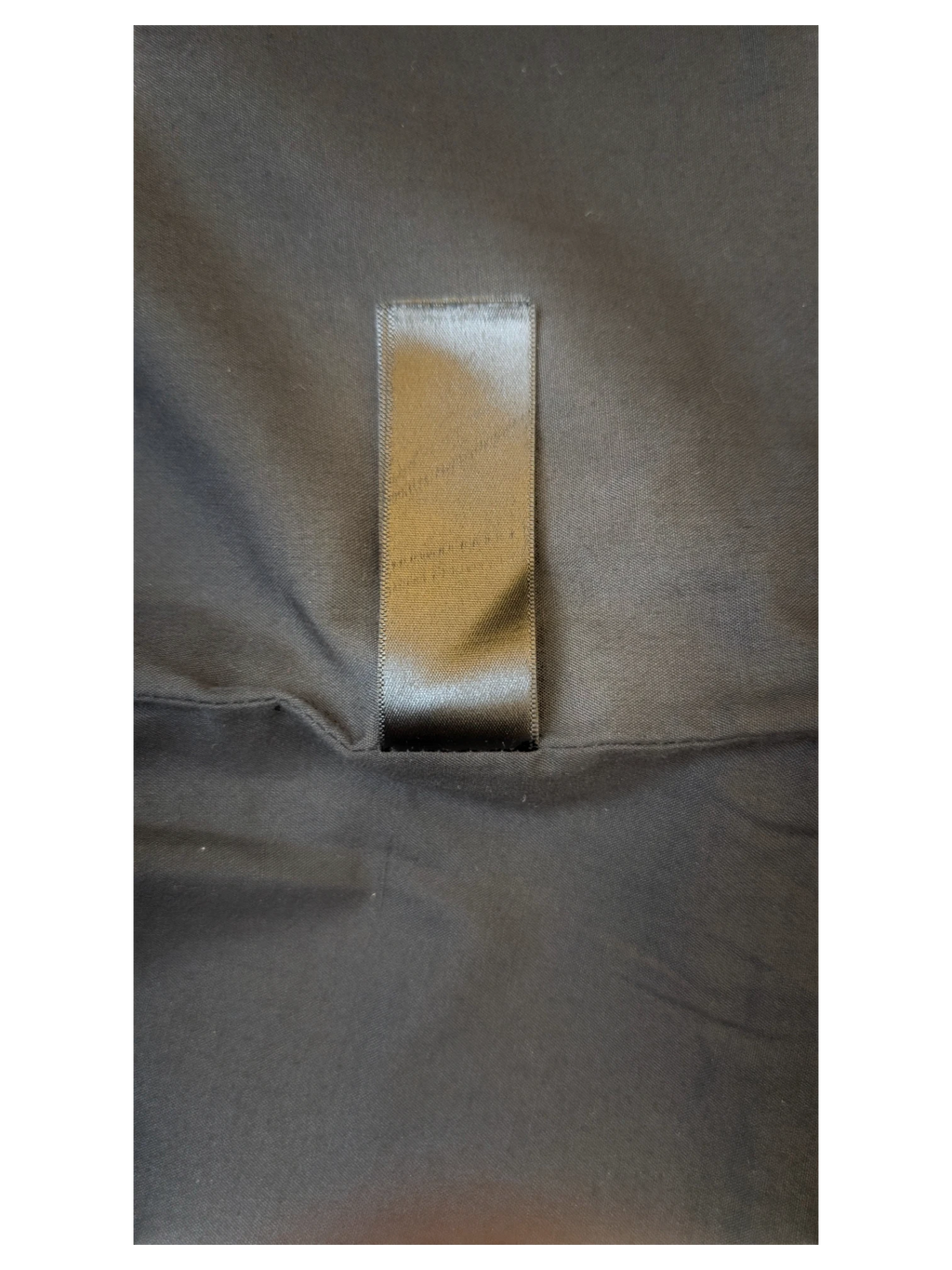 Black satin clothing label on a JAKE & IPI TOPSHOP faux leather mini skirt interior lining.