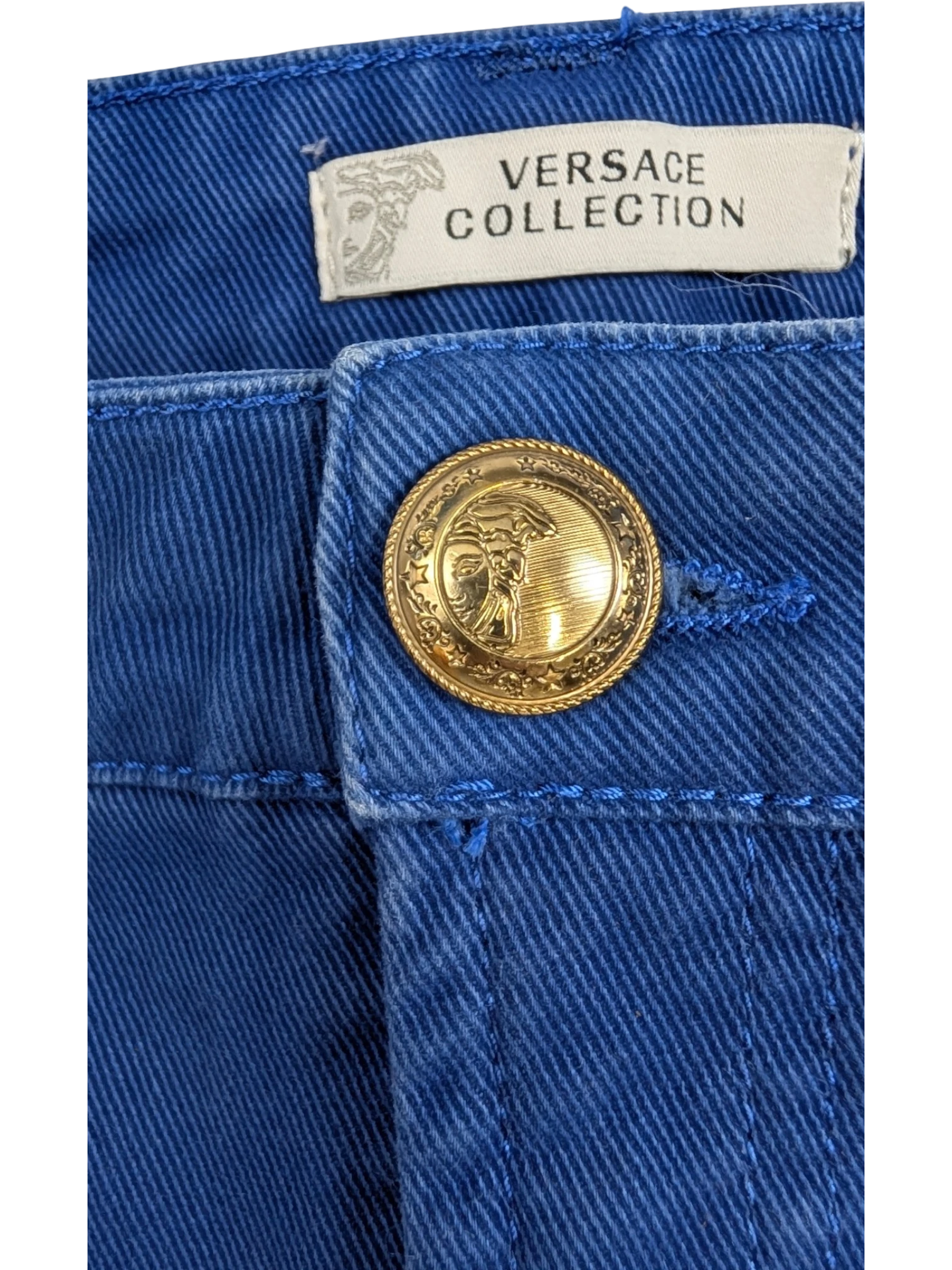 JAKE & IPI Versace Collection royal blue stretch cotton mini skirt with gold Medusa button and back pocket detail.