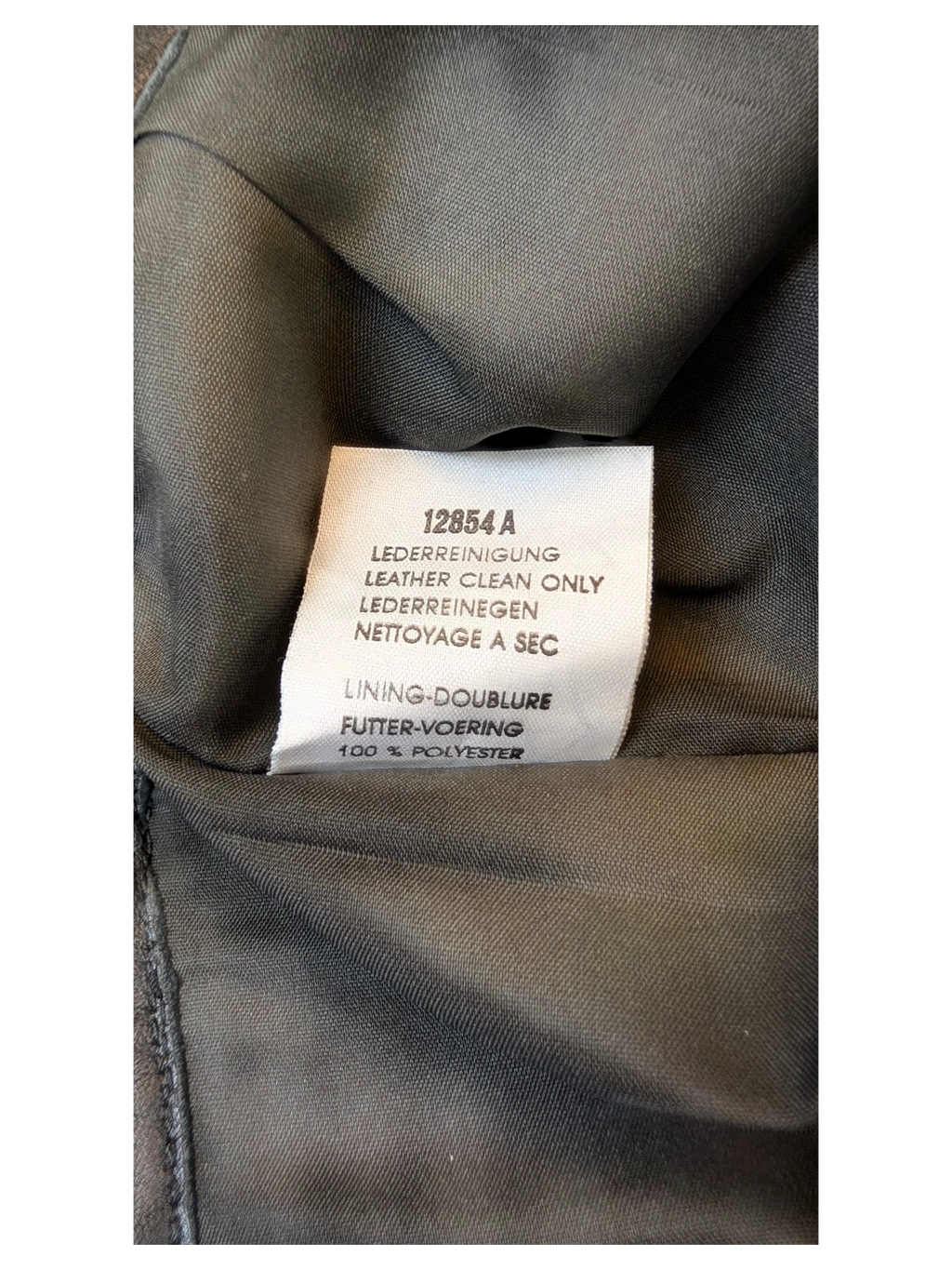 JAKE & IPI Vivien Caron leather skirt care label showing leather clean only instructions and polyester lining