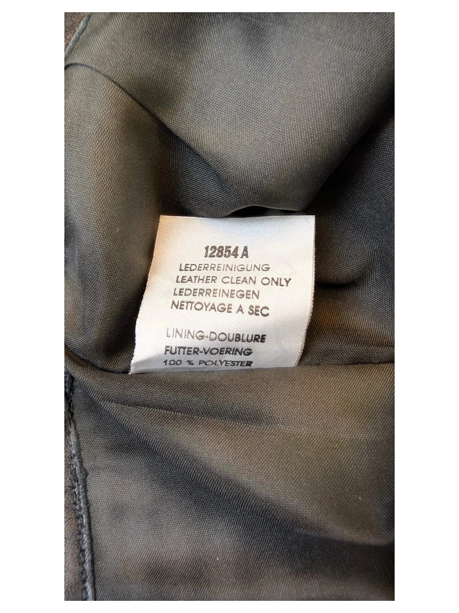 JAKE & IPI Vivien Caron leather skirt care label showing leather clean only instructions and polyester lining