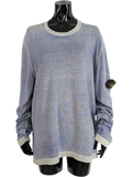 Stone Island blue mélange crewneck knit sweater with light grey ribbed collar, cuffs, and hem. Features iconic compass patch on left sleeve. 100% cotton.