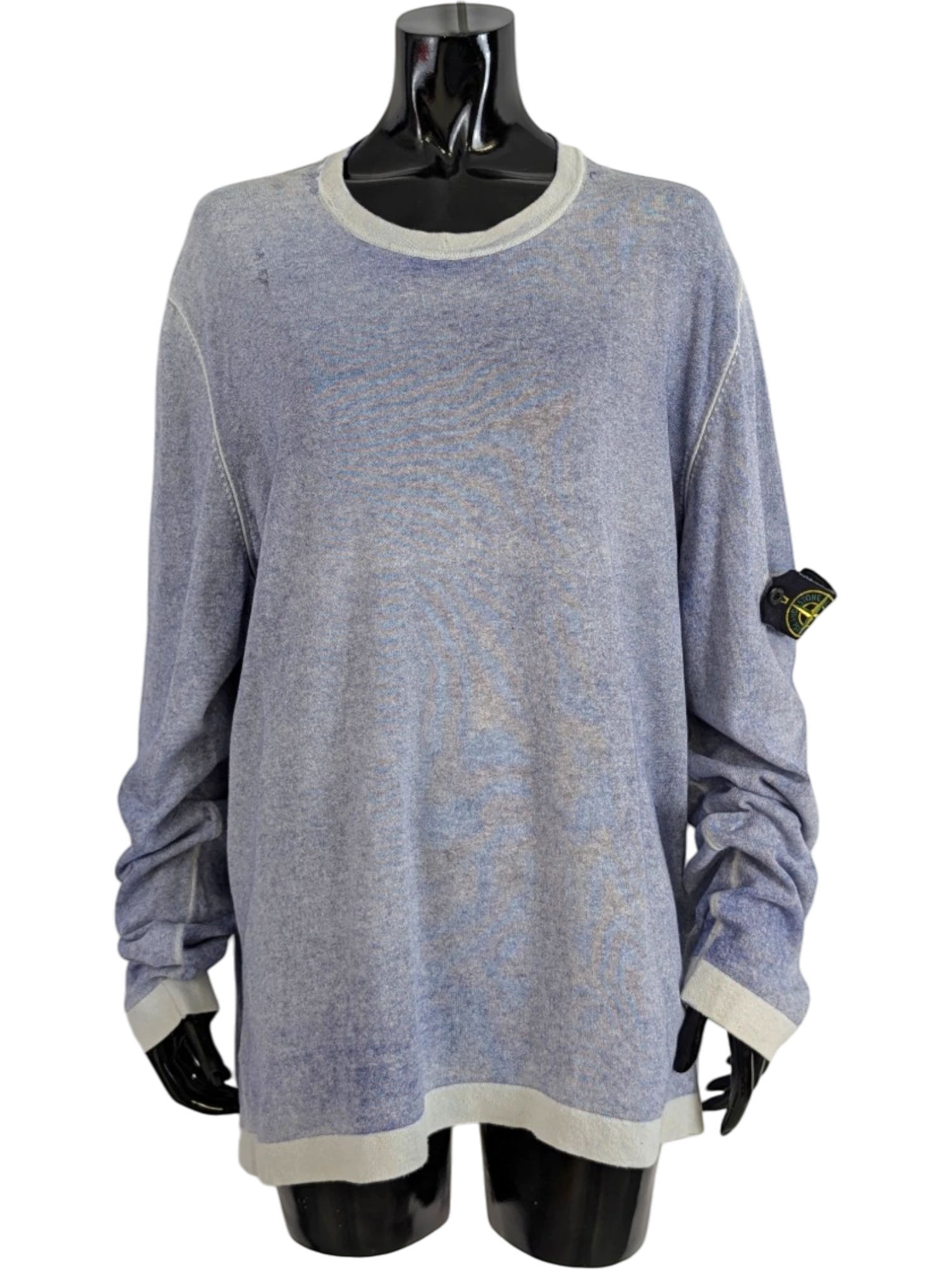 Stone Island blue mélange crewneck knit sweater with light grey ribbed collar, cuffs, and hem. Features iconic compass patch on left sleeve. 100% cotton.