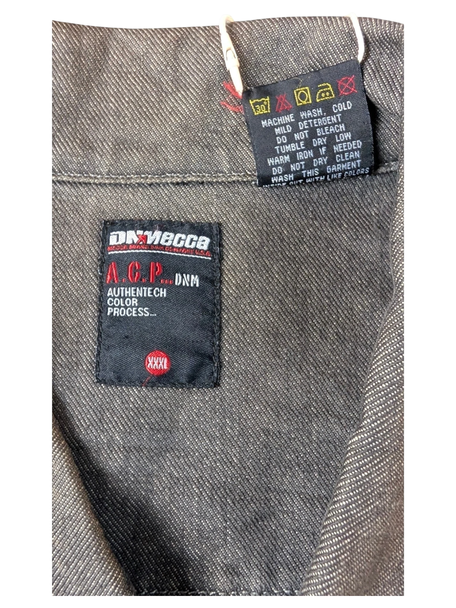 JAKE & IPI A.C.P. Denim jacket in dark grey with Authentitech color process detail.