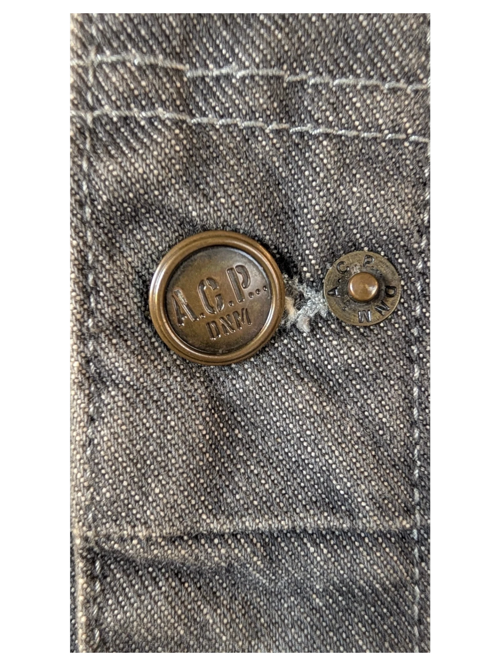 JAKE & IPI A.C.P. Denim jacket with bronze button detail. Grey denim fabric.