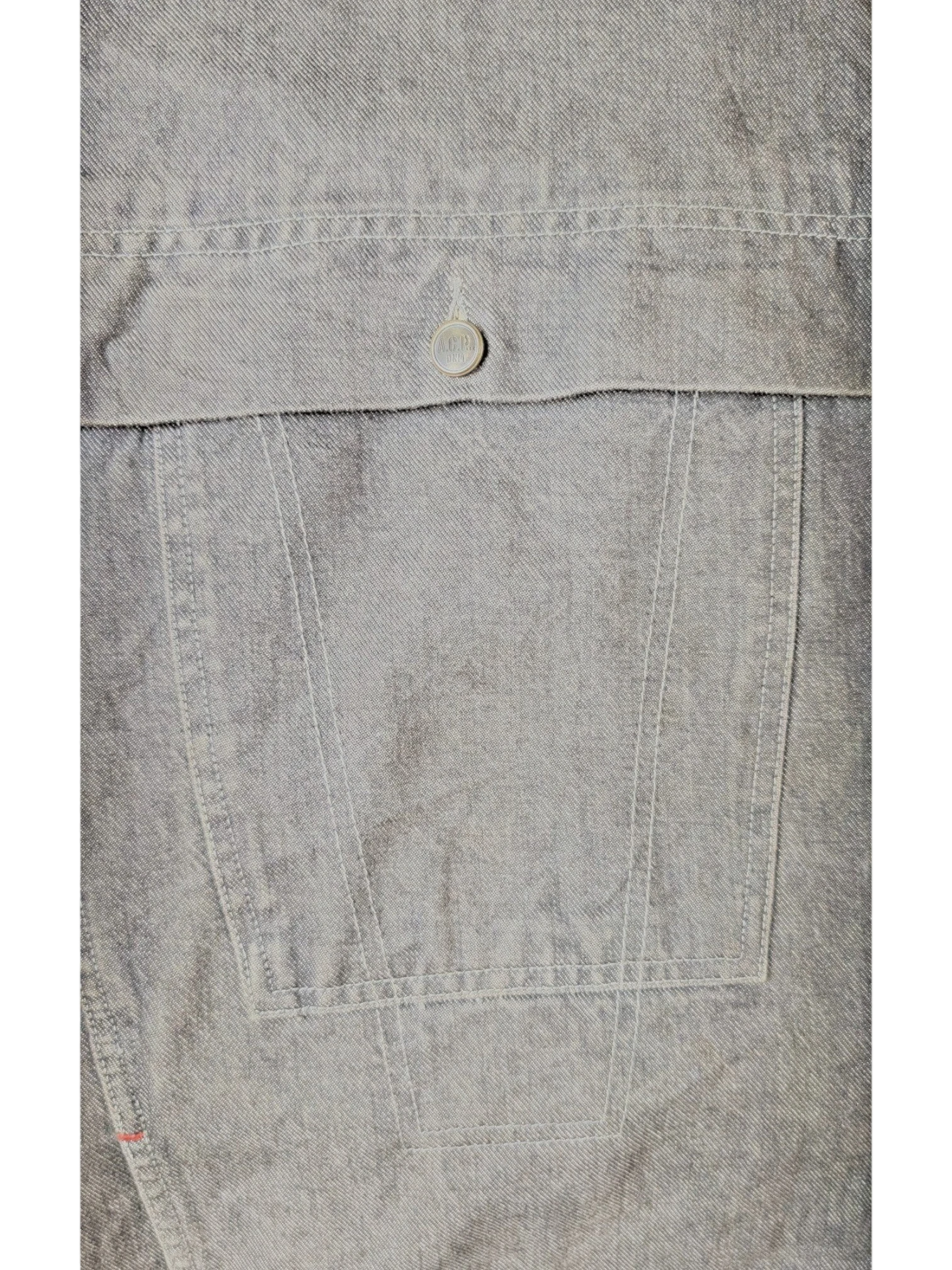 JAKE & IPI A.C.P denim jacket in grey, featuring a chest pocket with a branded button and contrast stitching.