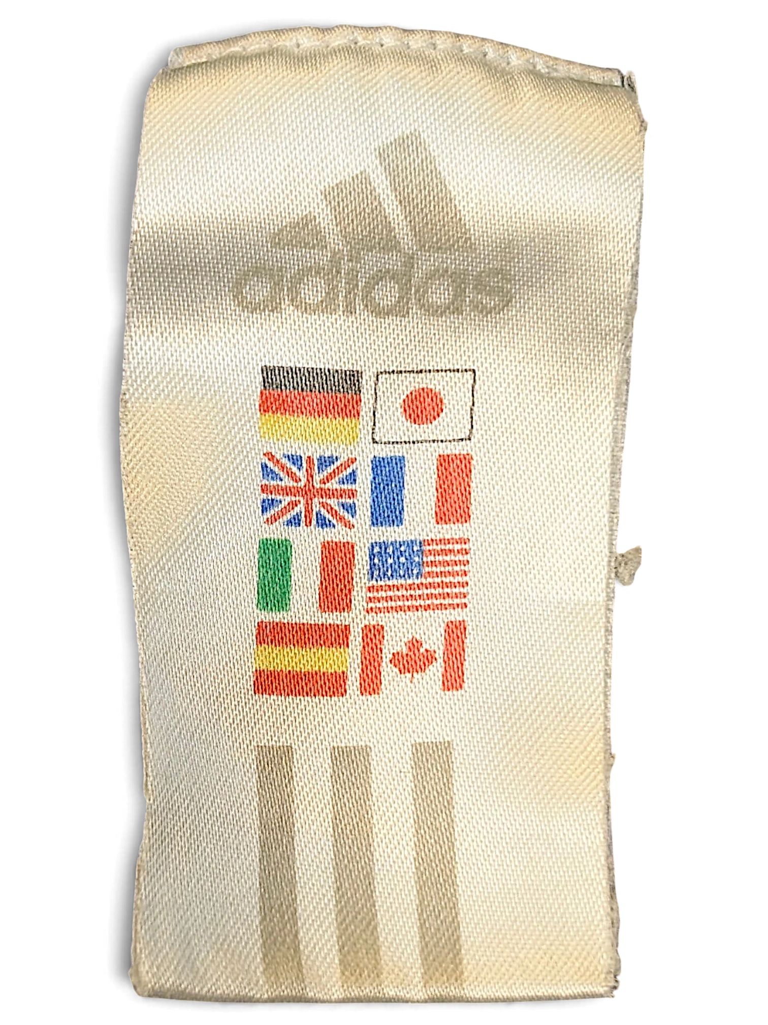 JAKE & IPI adidas clothing label featuring the brand logo and international flags on a white fabric tag