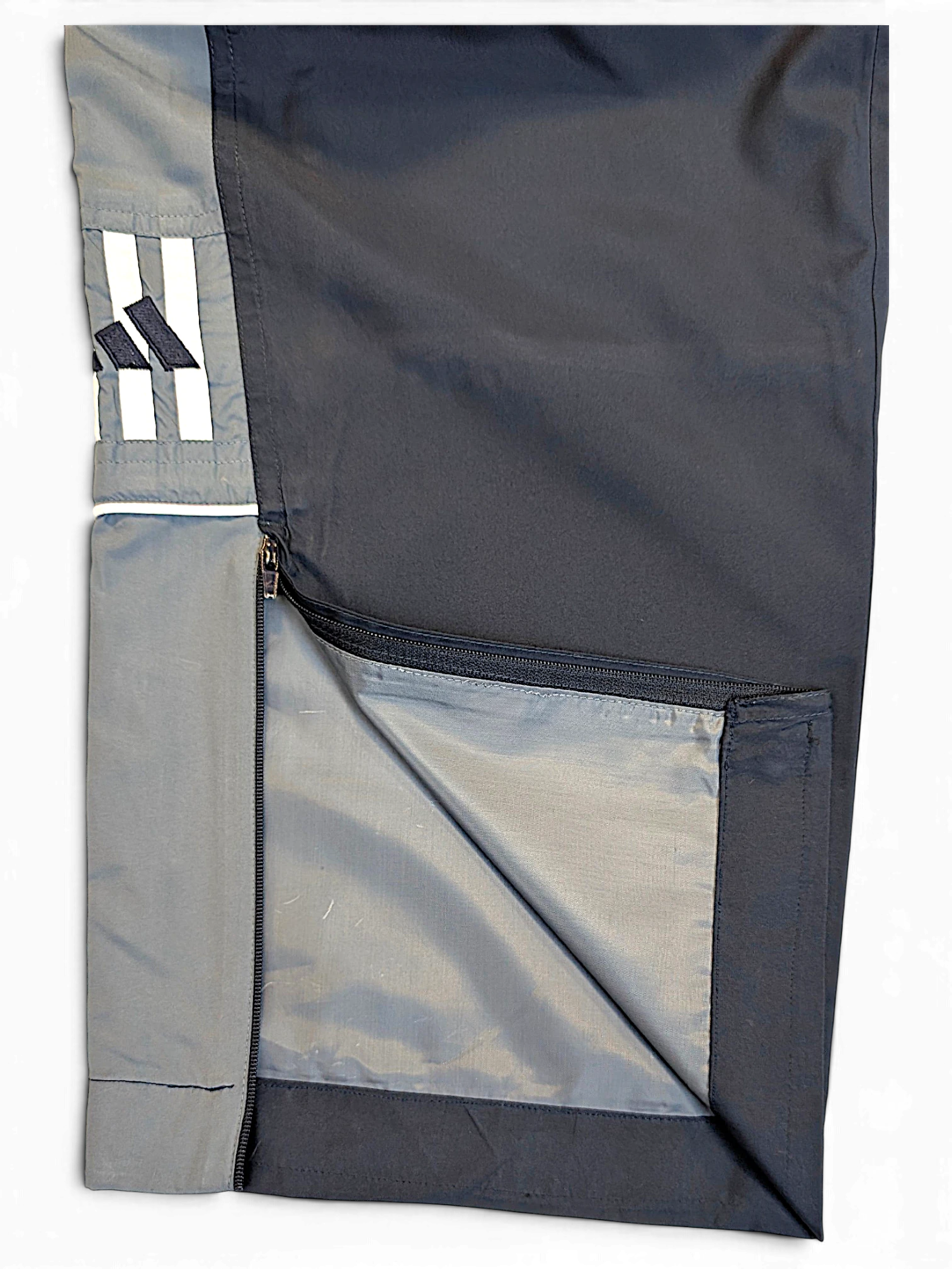 JAKE & IPI pre-owned adidas navy and grey track pants with contrast side panel, zipper detail, and embroidered logo.