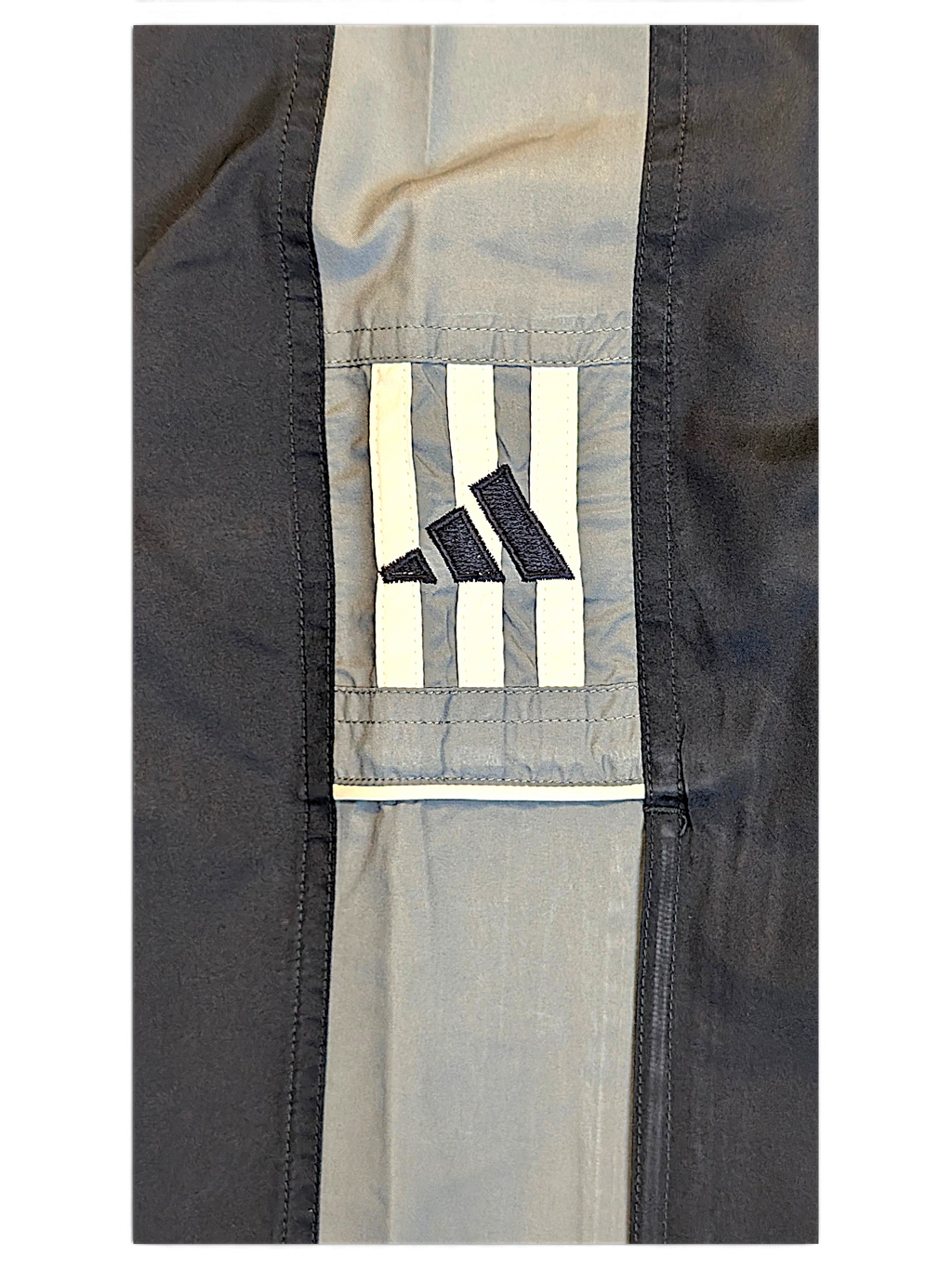 JAKE & IPI pre-owned adidas navy and grey track pants featuring embroidered logo and contrast panel detail