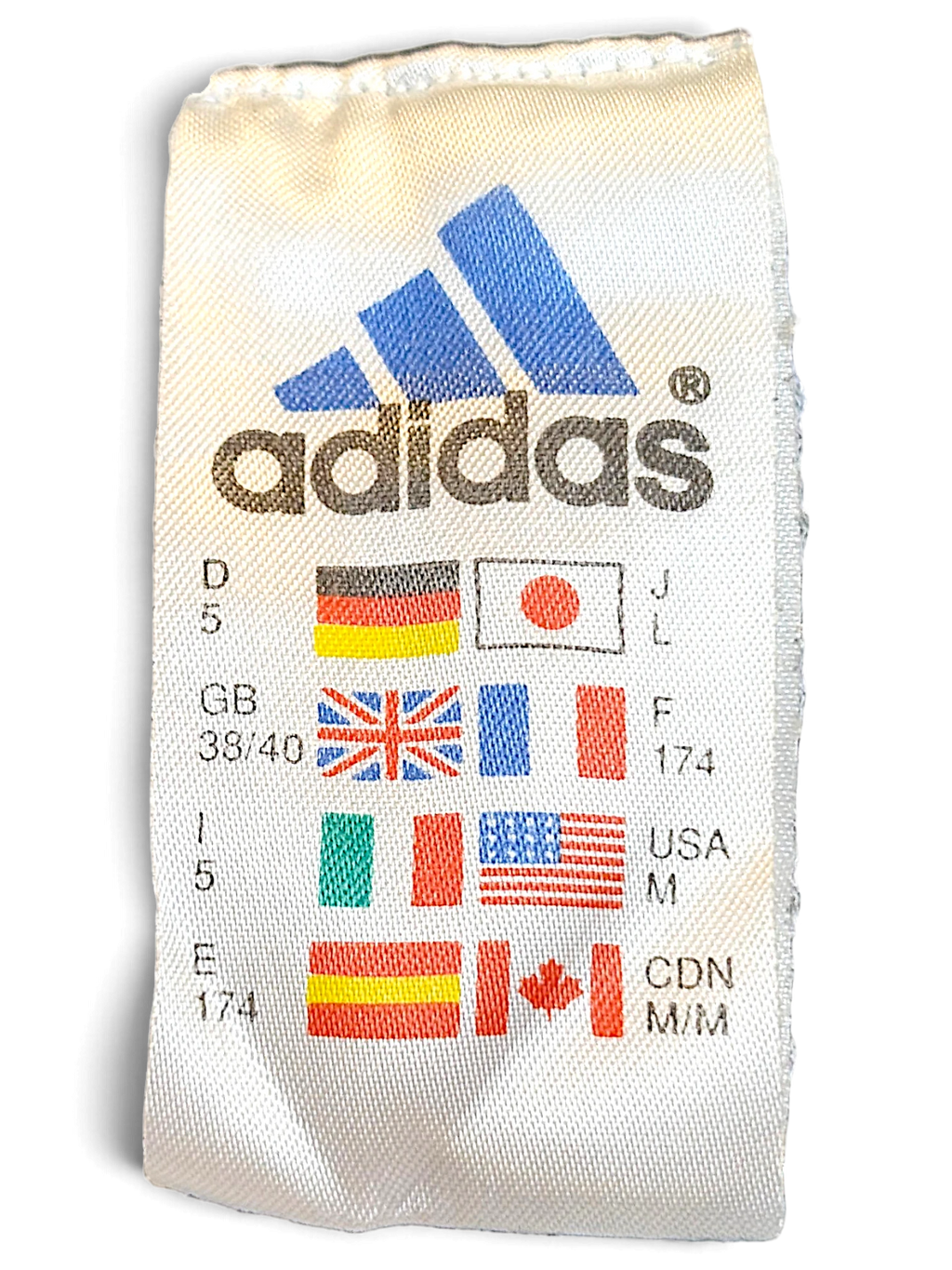 JAKE & IPI adidas track pants care label showing size M and international sizing standards