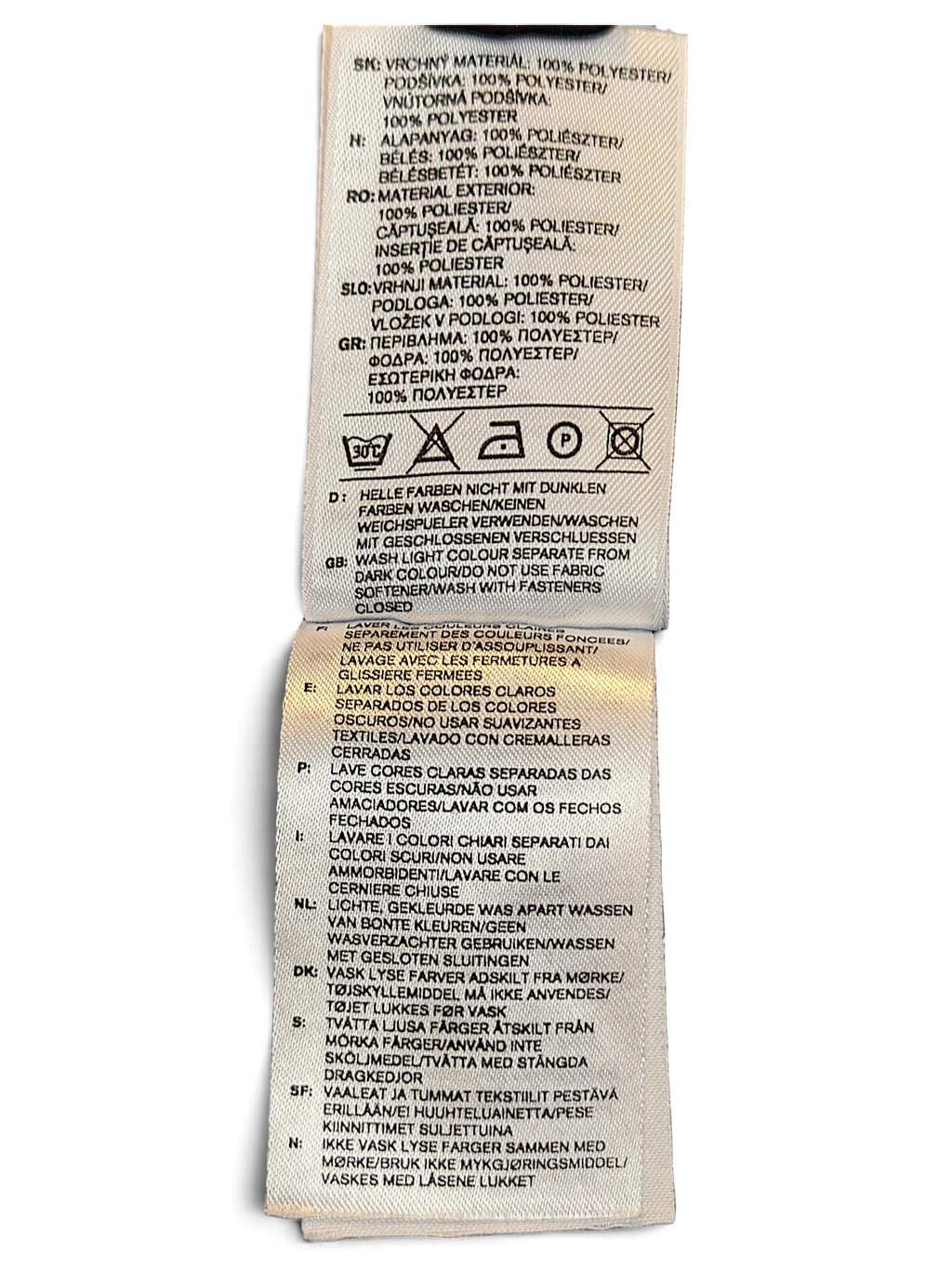 JAKE & IPI adidas track pants care label showing 100 percent polyester composition and laundry instructions
