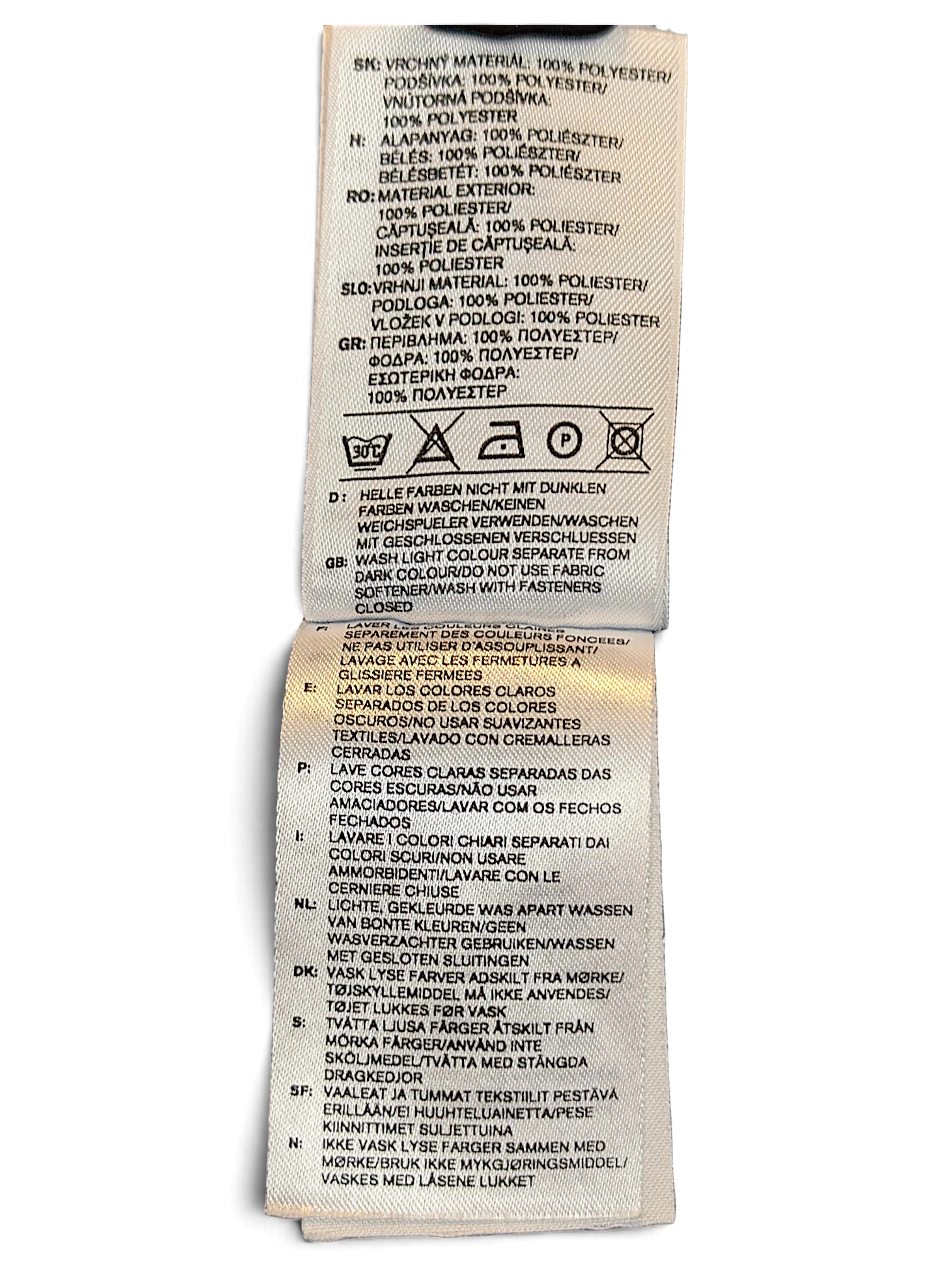 JAKE & IPI adidas track pants care label showing 100 percent polyester composition and laundry instructions