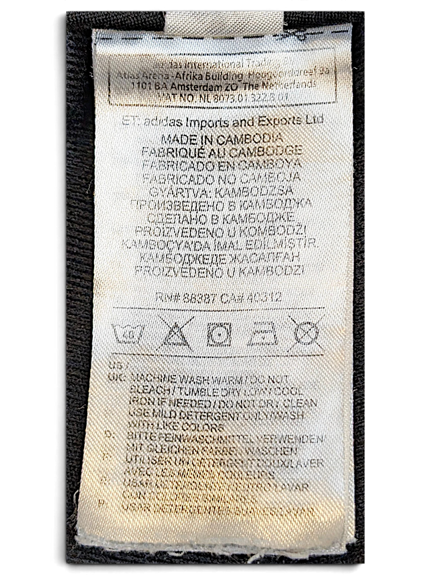 JAKE & IPI pre-owned adidas track pants care and origin label showing washing instructions and manufacturing details