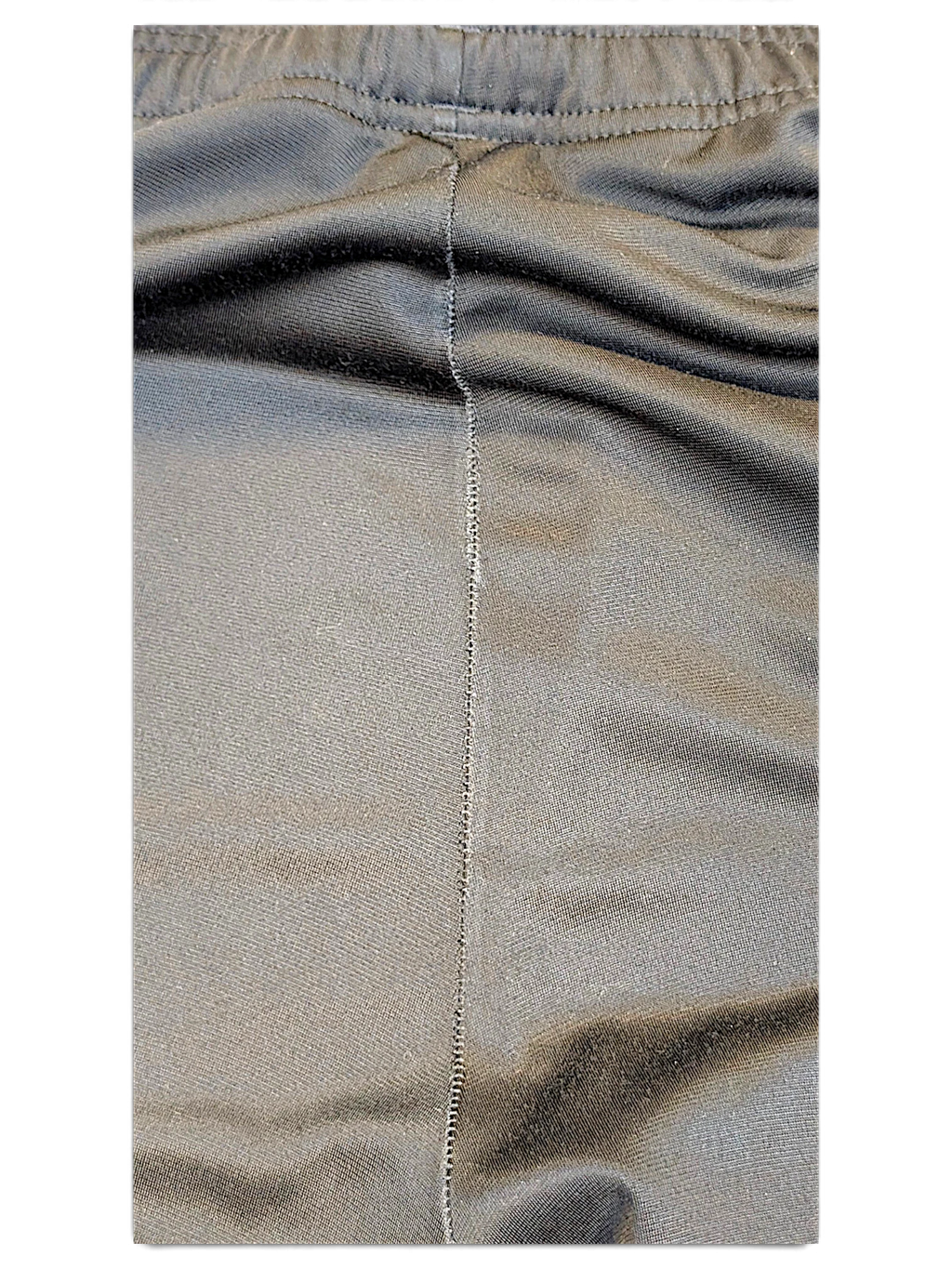 Close-up of the black fabric and seam detail on JAKE & IPI adidas track pants