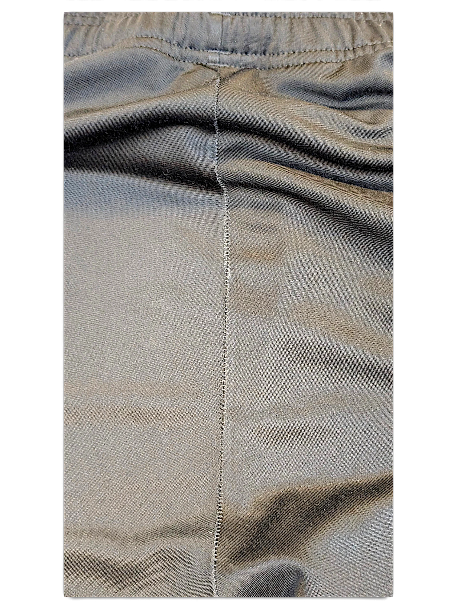 Close-up of the black fabric and seam detail on JAKE & IPI adidas track pants