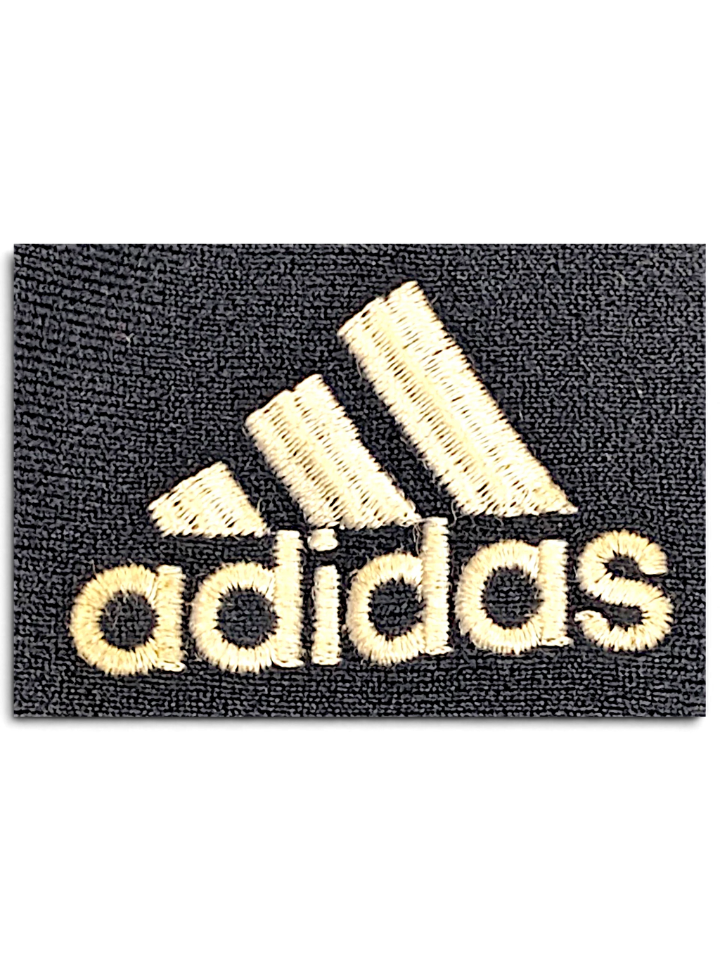 Close-up of the embroidered adidas logo on blue velour fabric from JAKE & IPI