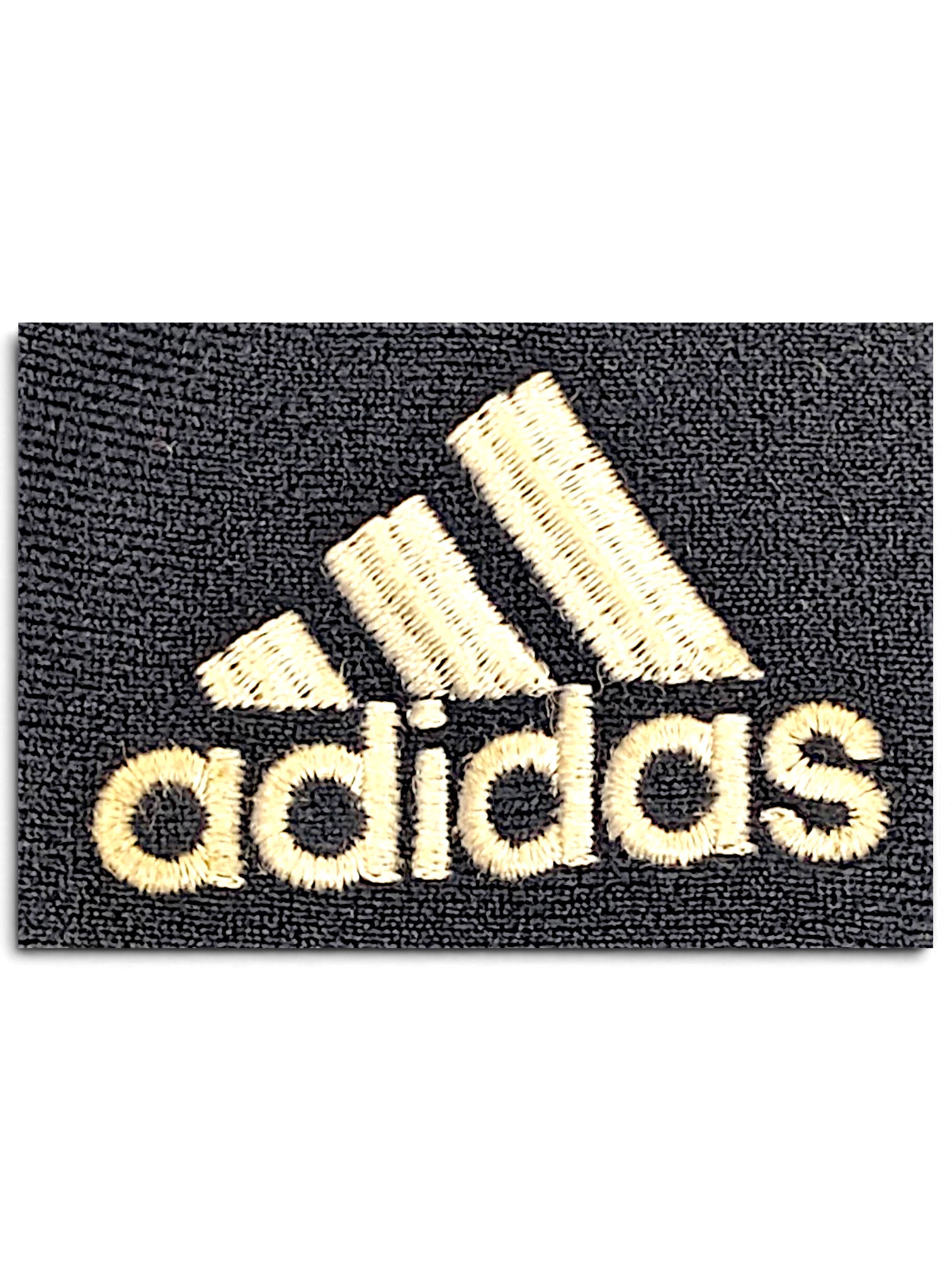 Close-up of the embroidered adidas logo on blue velour fabric from JAKE & IPI